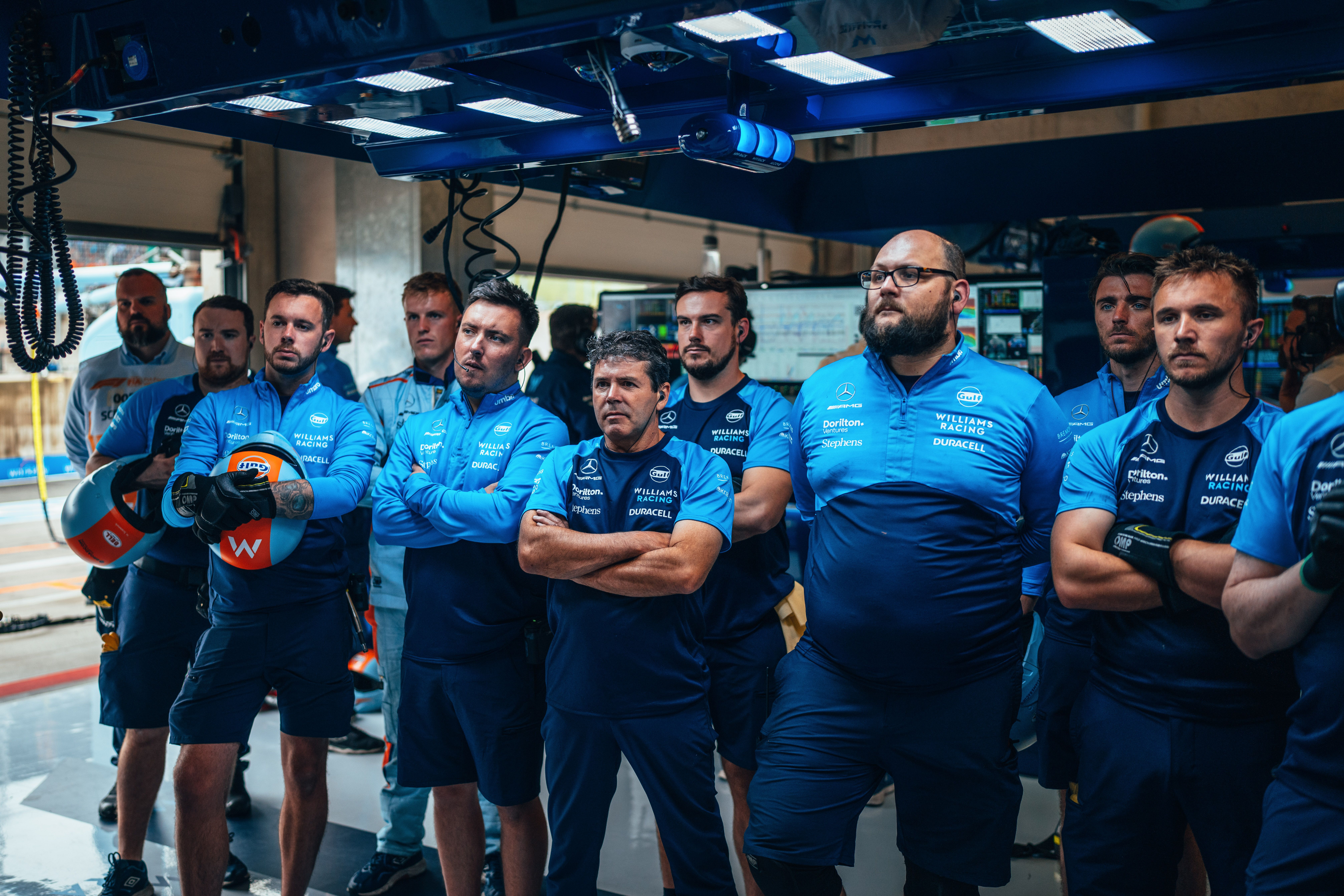The crew watch the tense on-track action from the dry shelter of the Williams Racing garage.