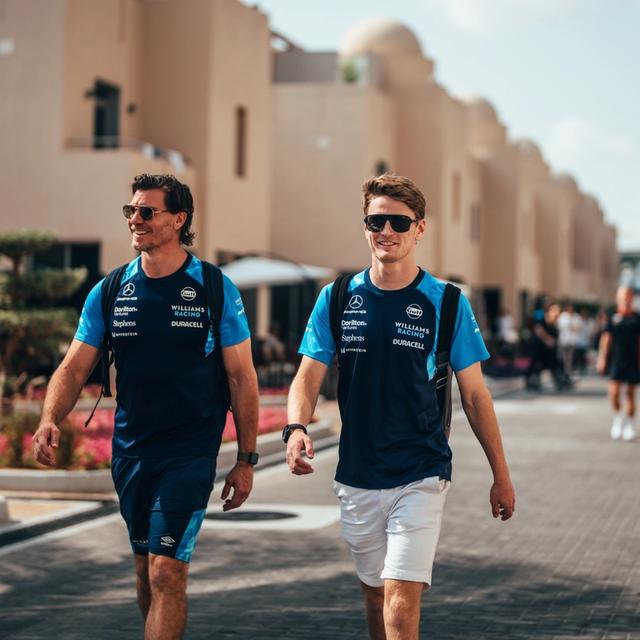 Logan and Ben smile under the sun as they arrive in the paddock.