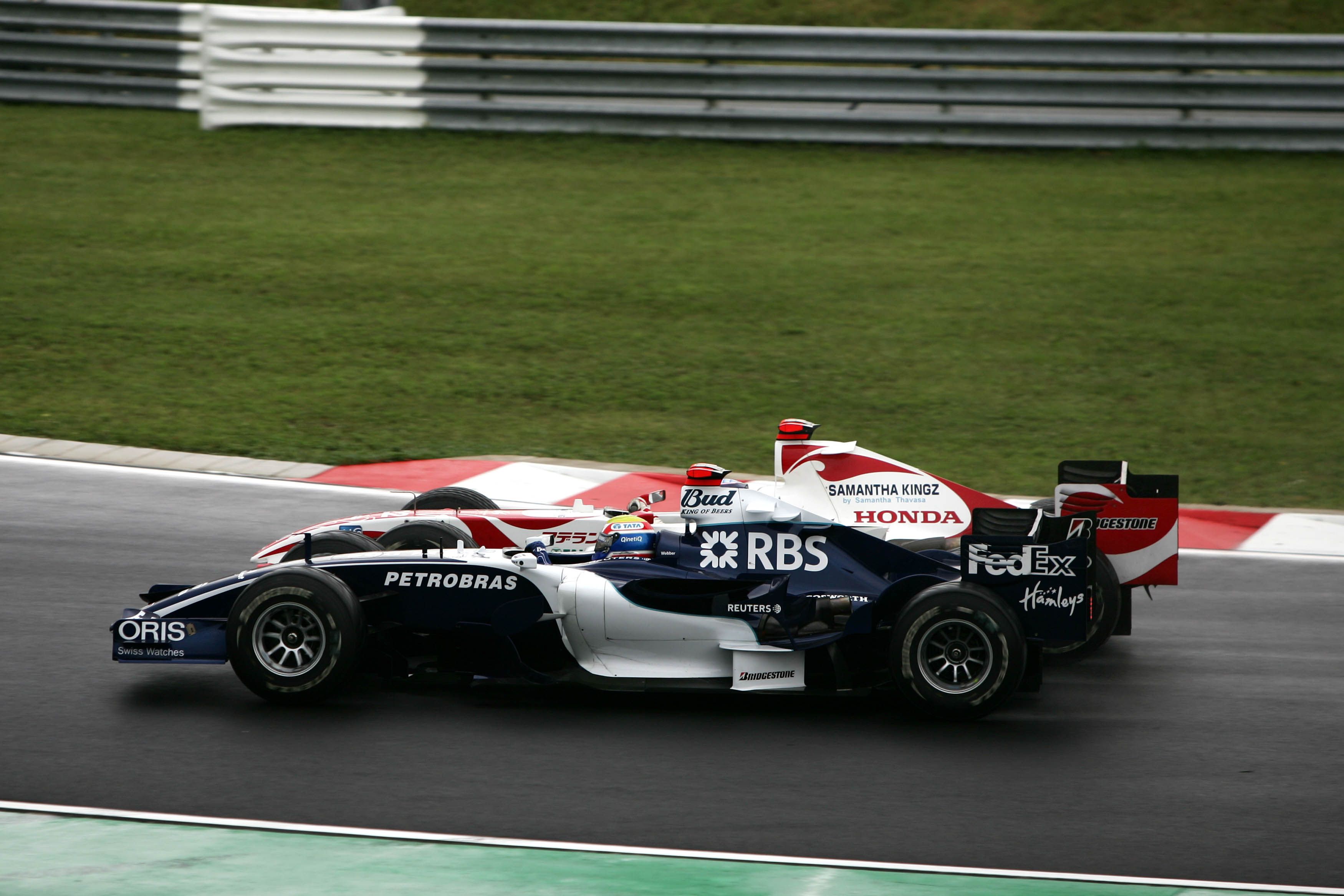 Mark Webber goes wheel-to-wheel with Takuma Sato in 2006.