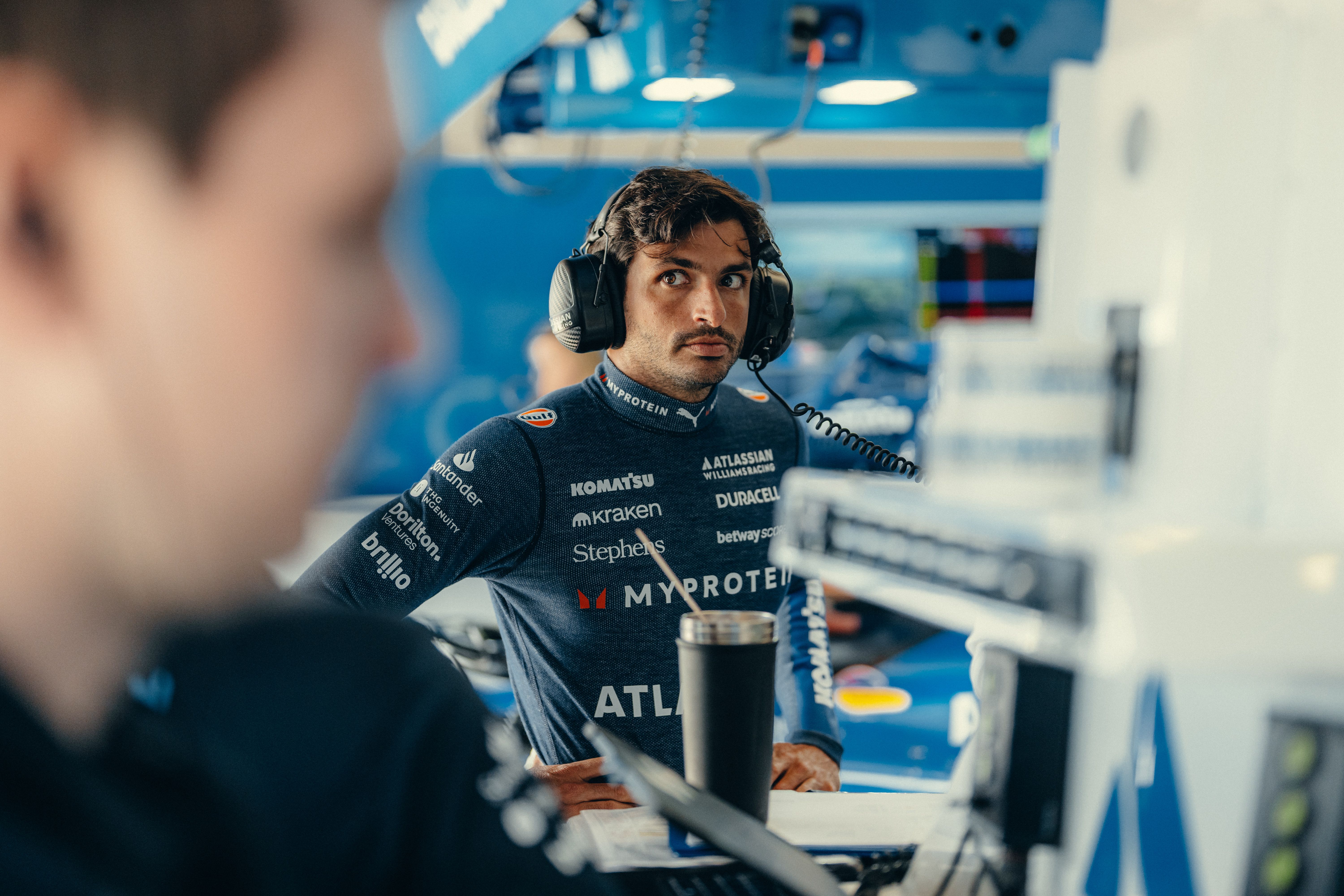 Carlos checks in with the engineers in the garage
