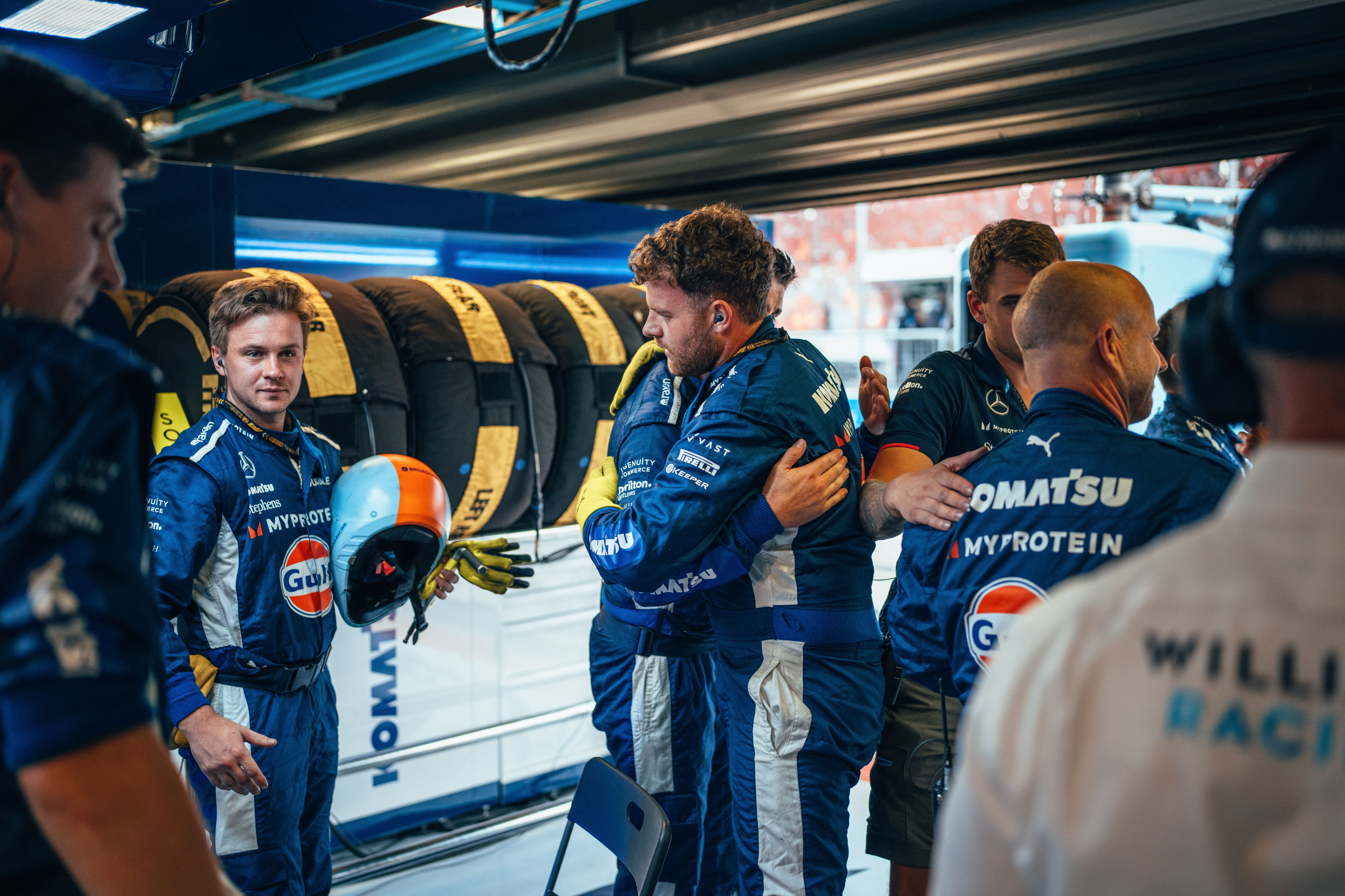 The garage crew embrace in celebration