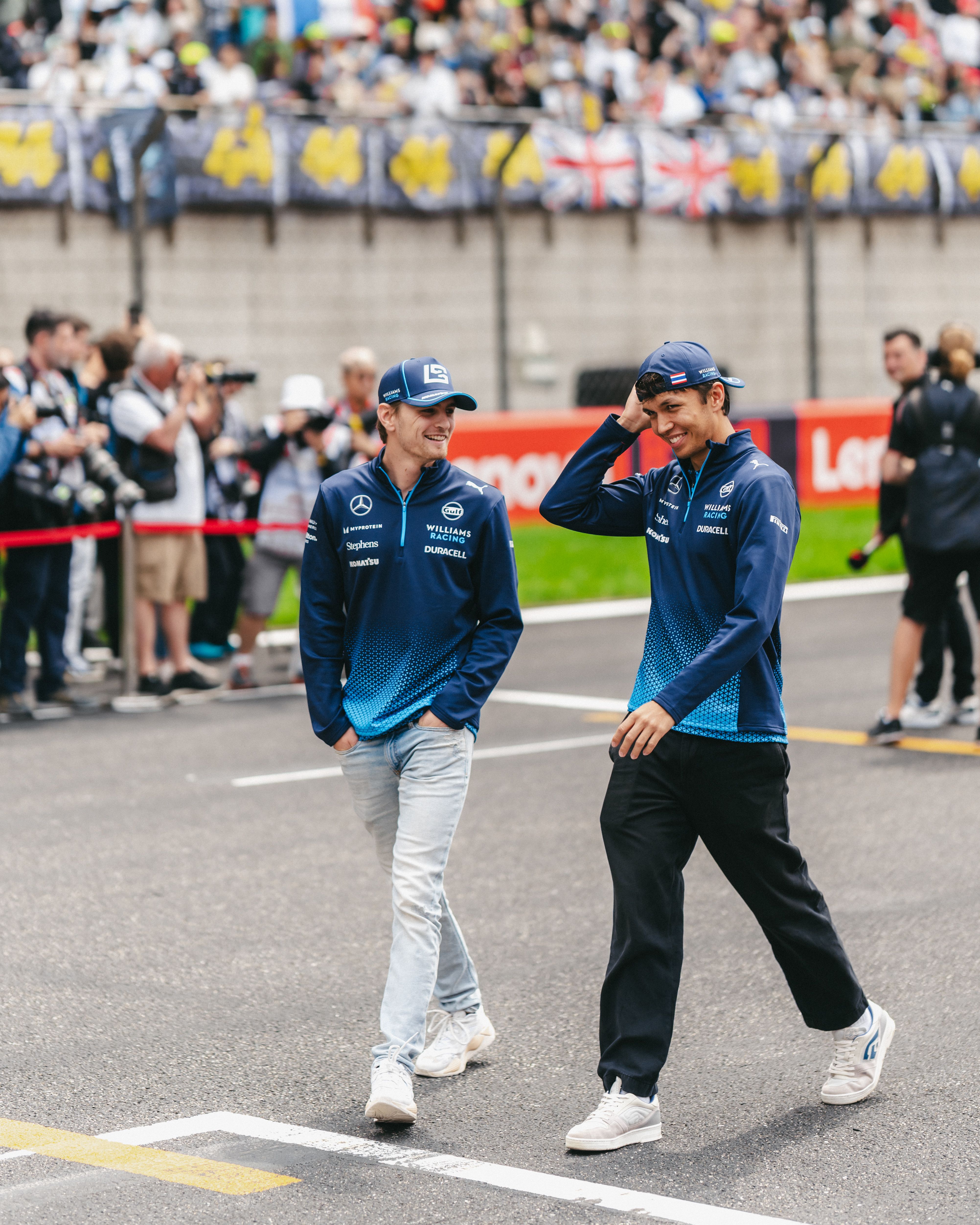 Logan and Alex share a laugh as they walk down the pit straight.