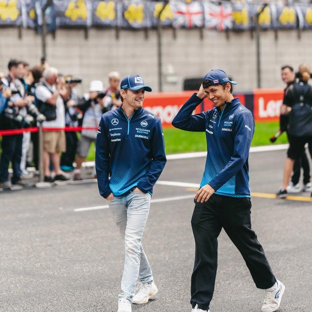 Logan and Alex share a laugh as they walk down the pit straight.