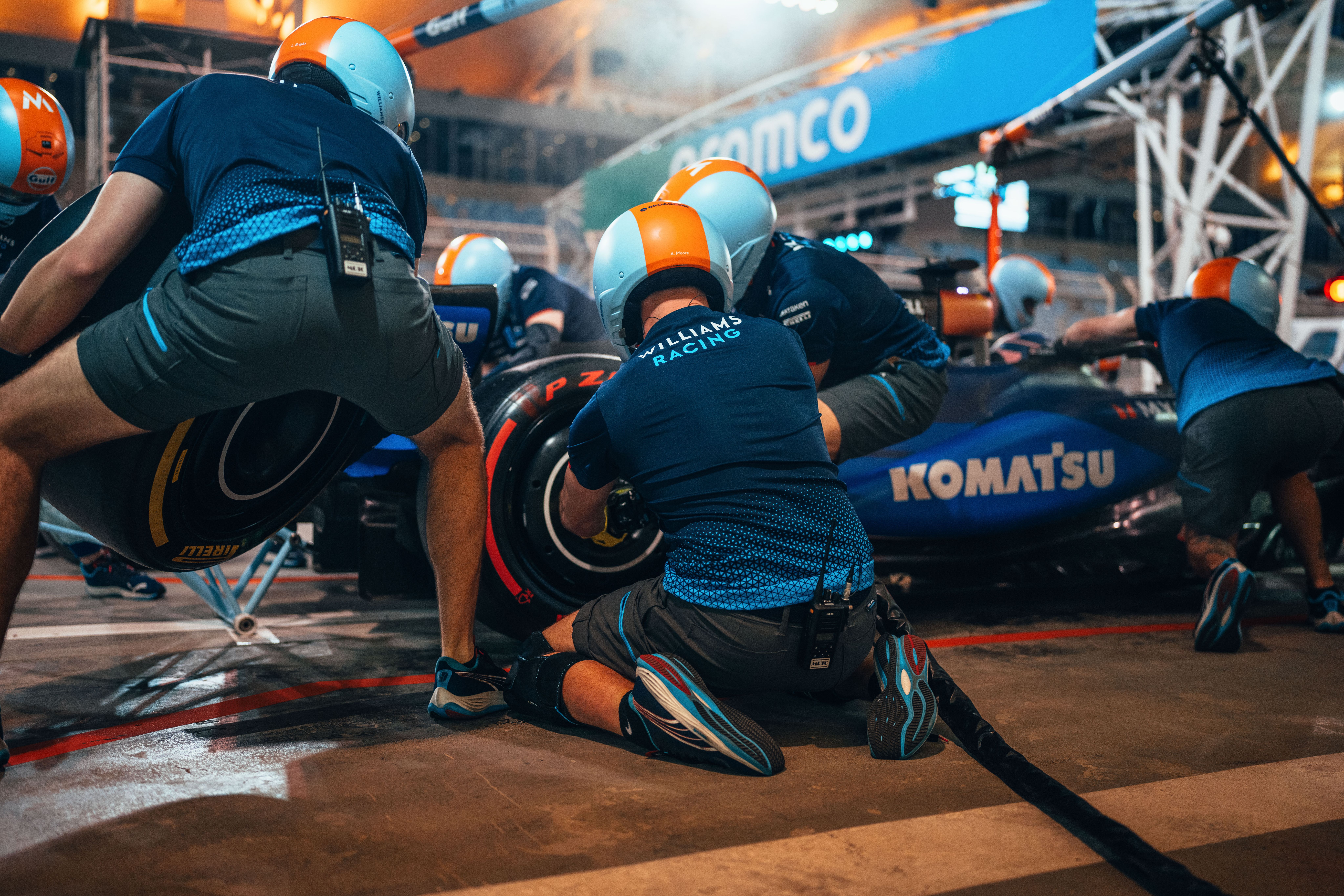 Soft tyres come off for a new set of medium as the pit crew get practising.