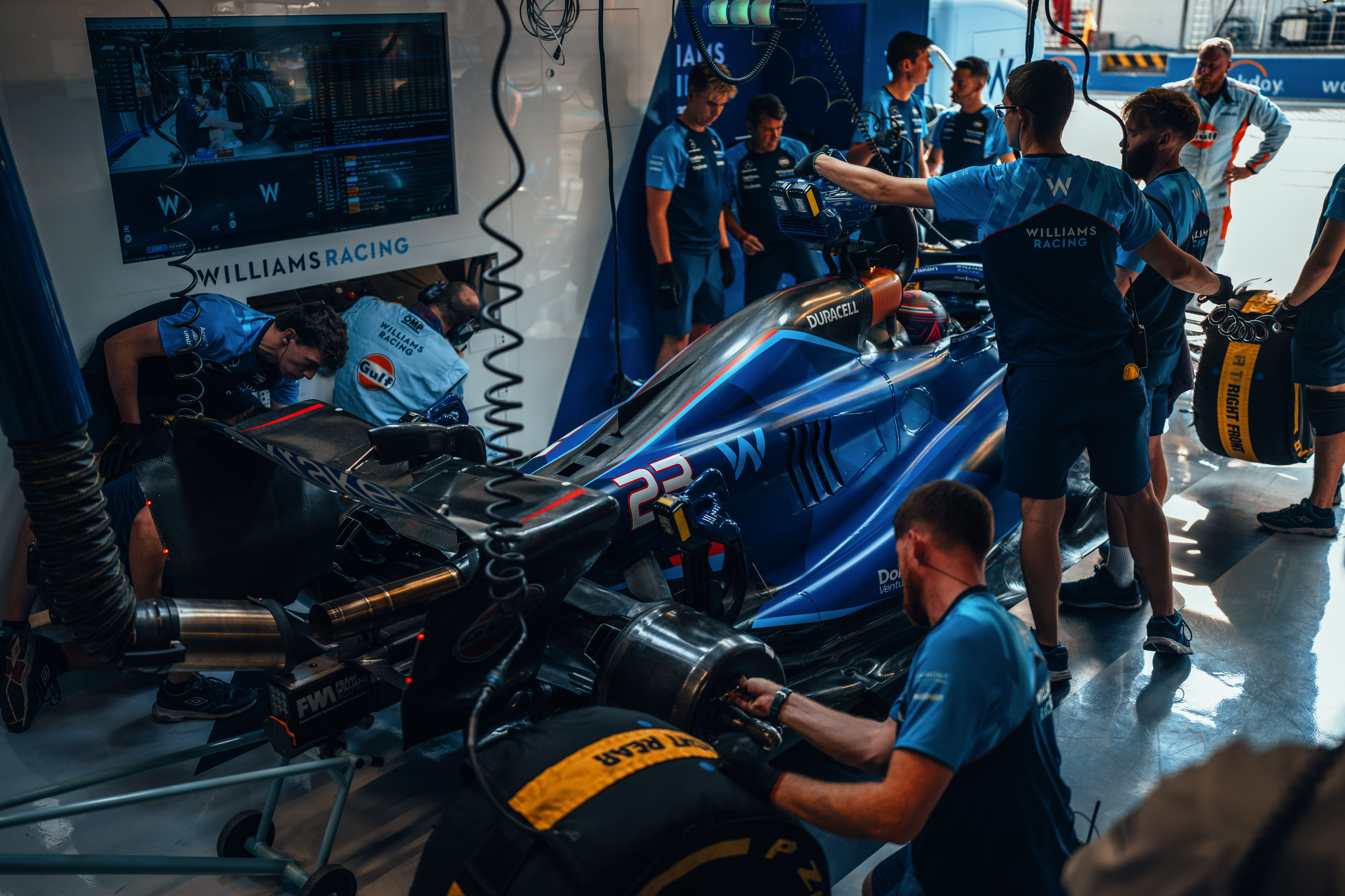 We work as a team. The Williams Racing mechanics get car #23 ready for another run.