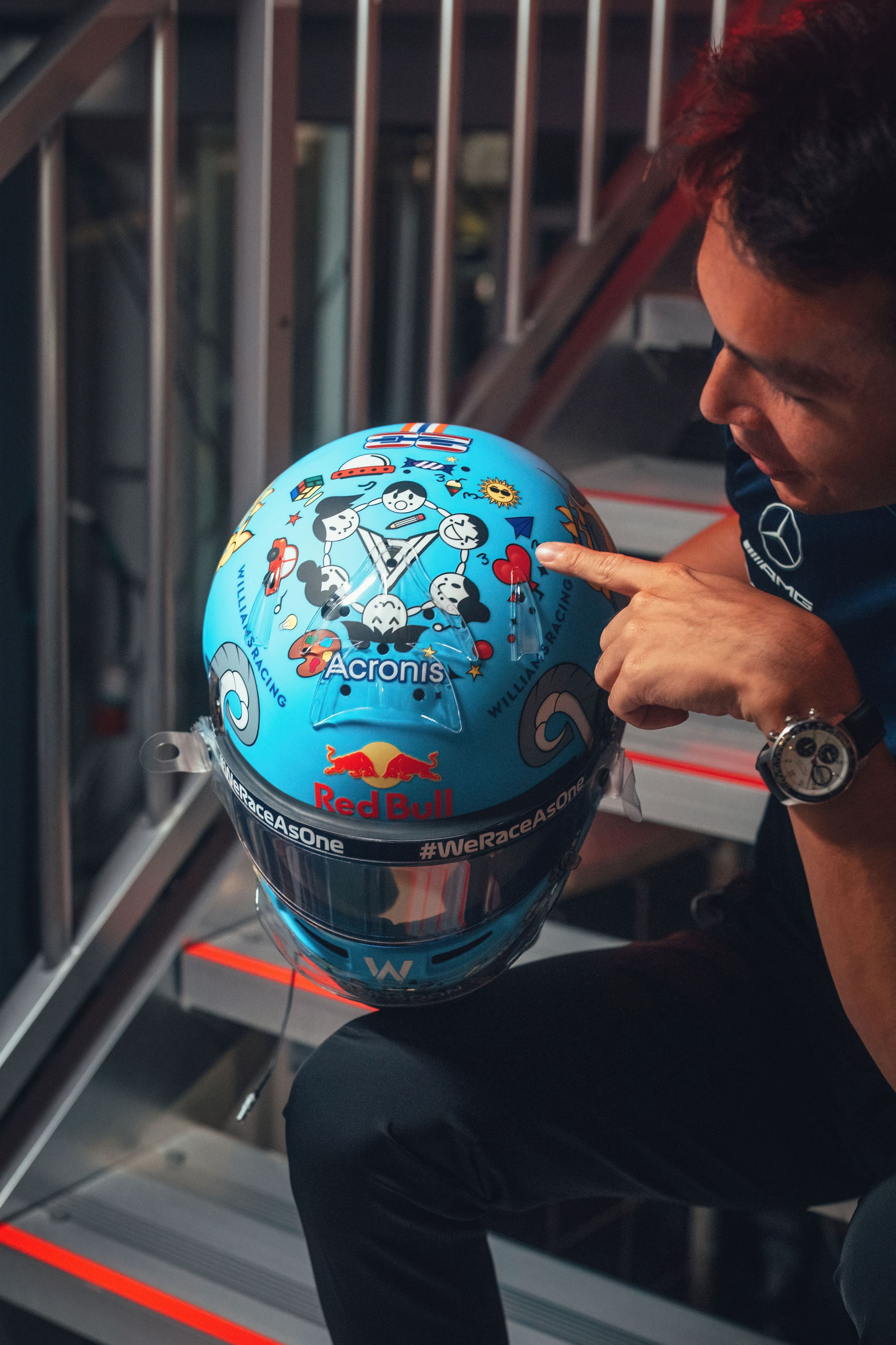 On the top, children are seen holding hands around Alex’s logo