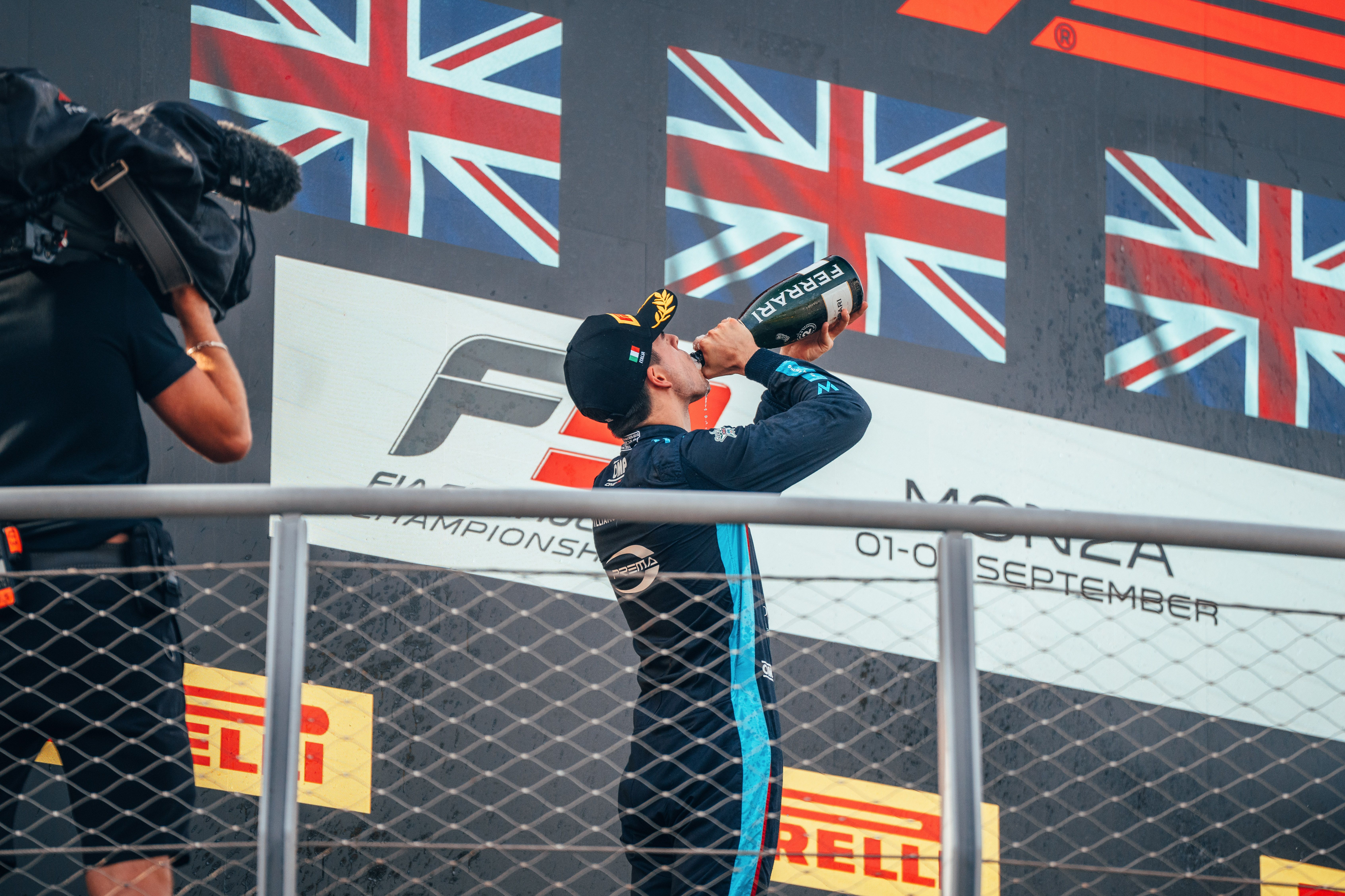 Zak takes a well-earned drink up on the podium.
