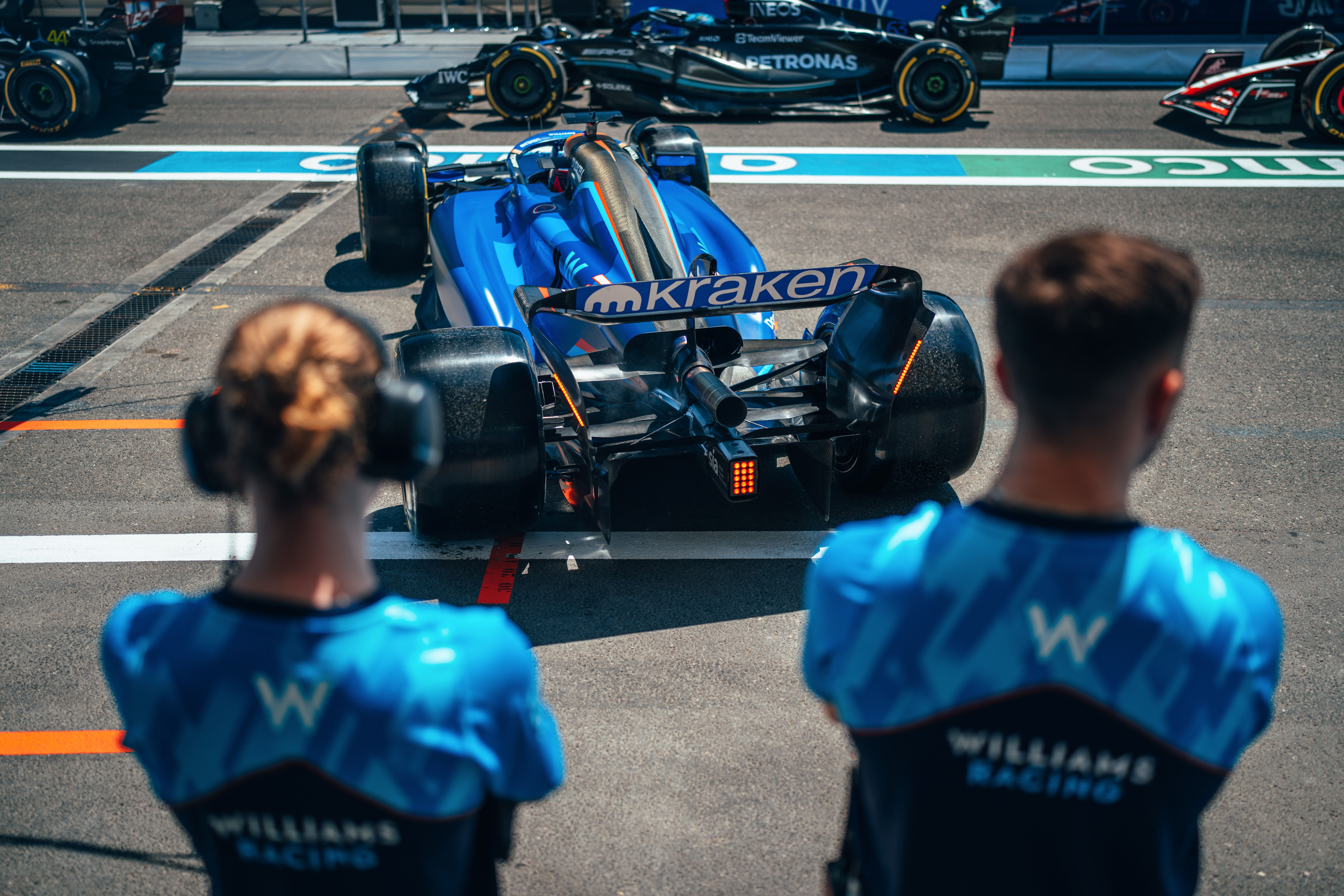 The queue begins to take to the track.