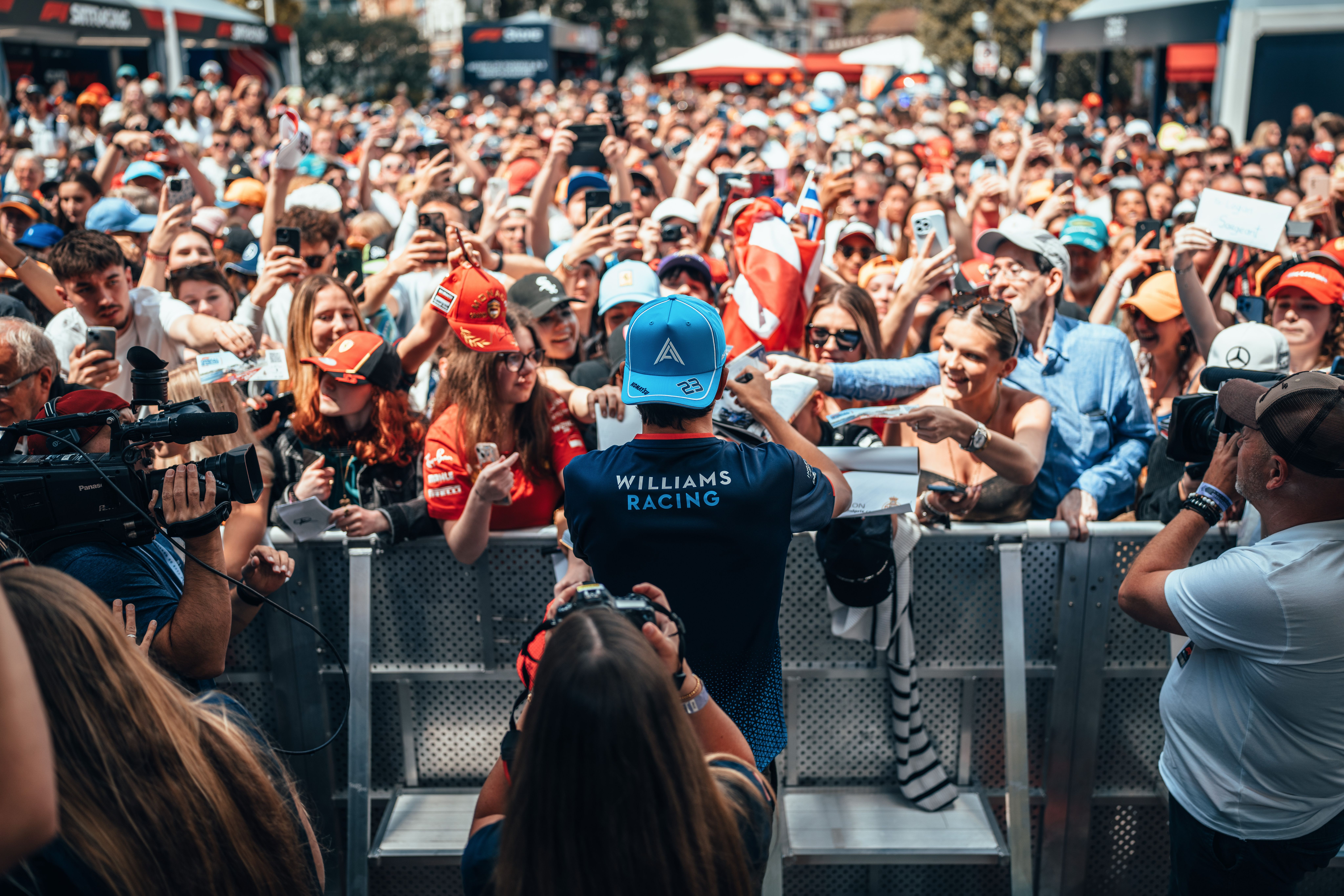 Alex takes the time to sign autographs for a huge Monaco crowd