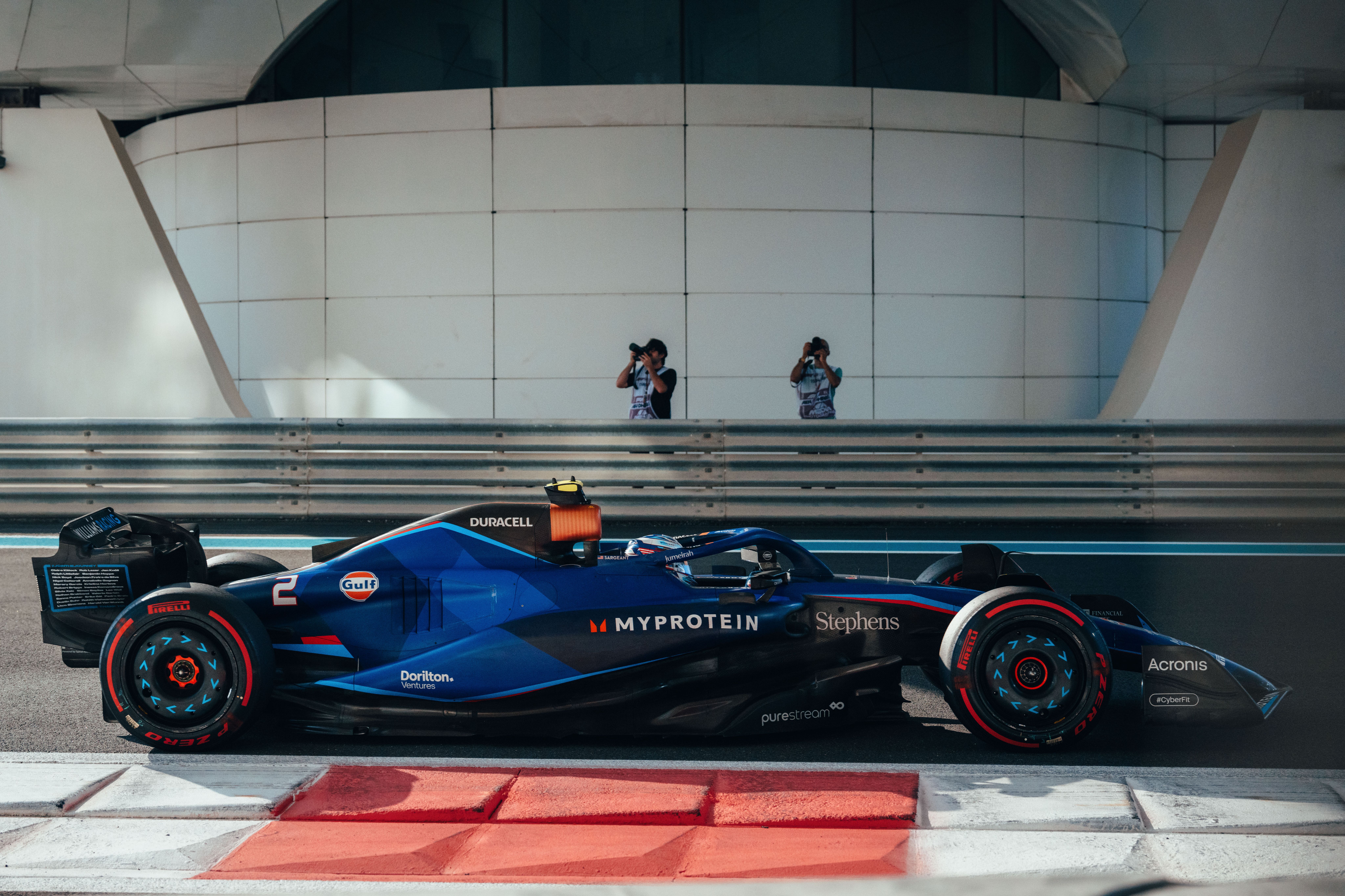 Logan in front of the lens. Photographers capture car #2 from both sides of the circuit.