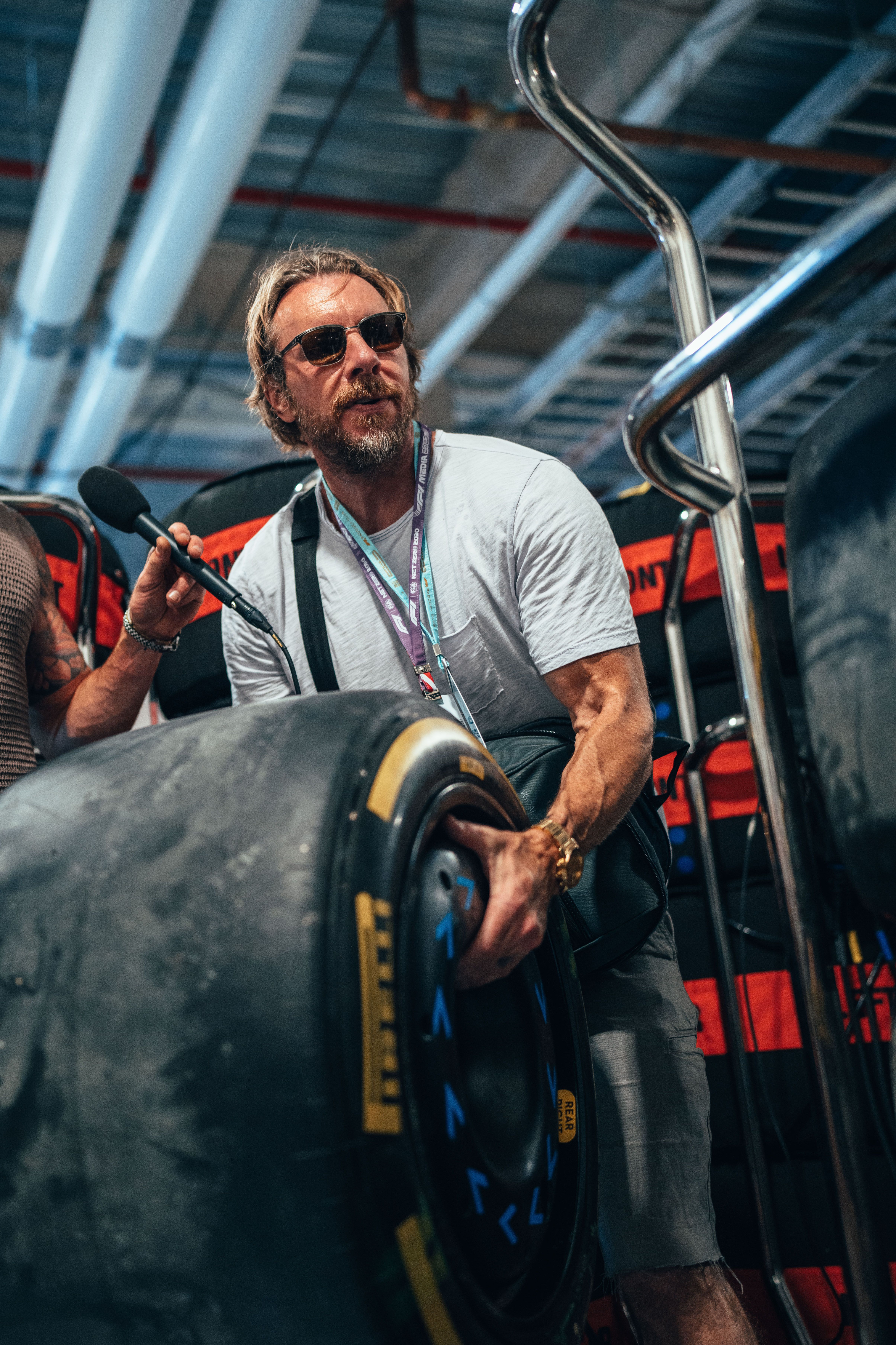 Dax Shepard helps stack the tyres ahead of FP3.