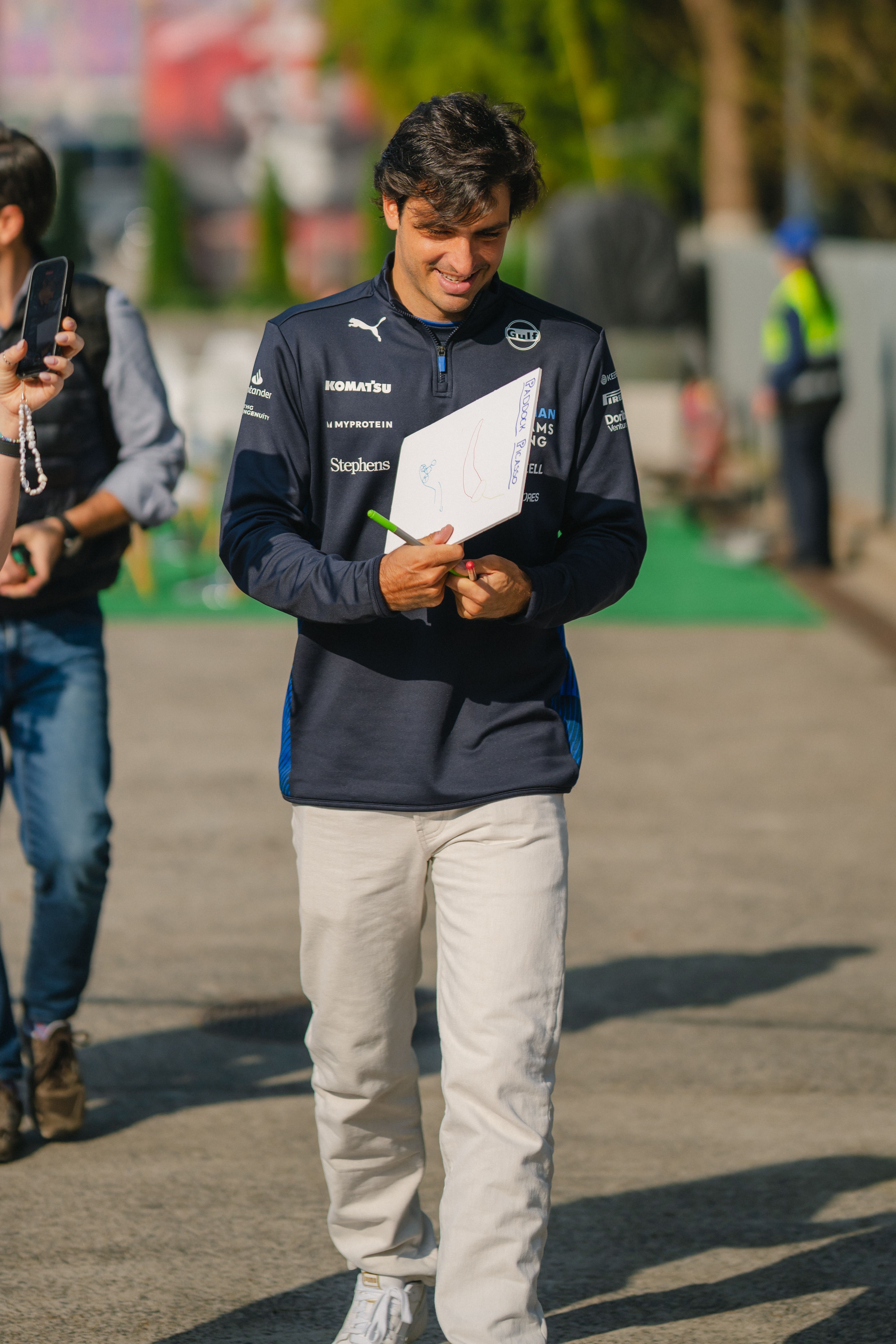 A big smile from Carlos as he delights a fan with his autograph