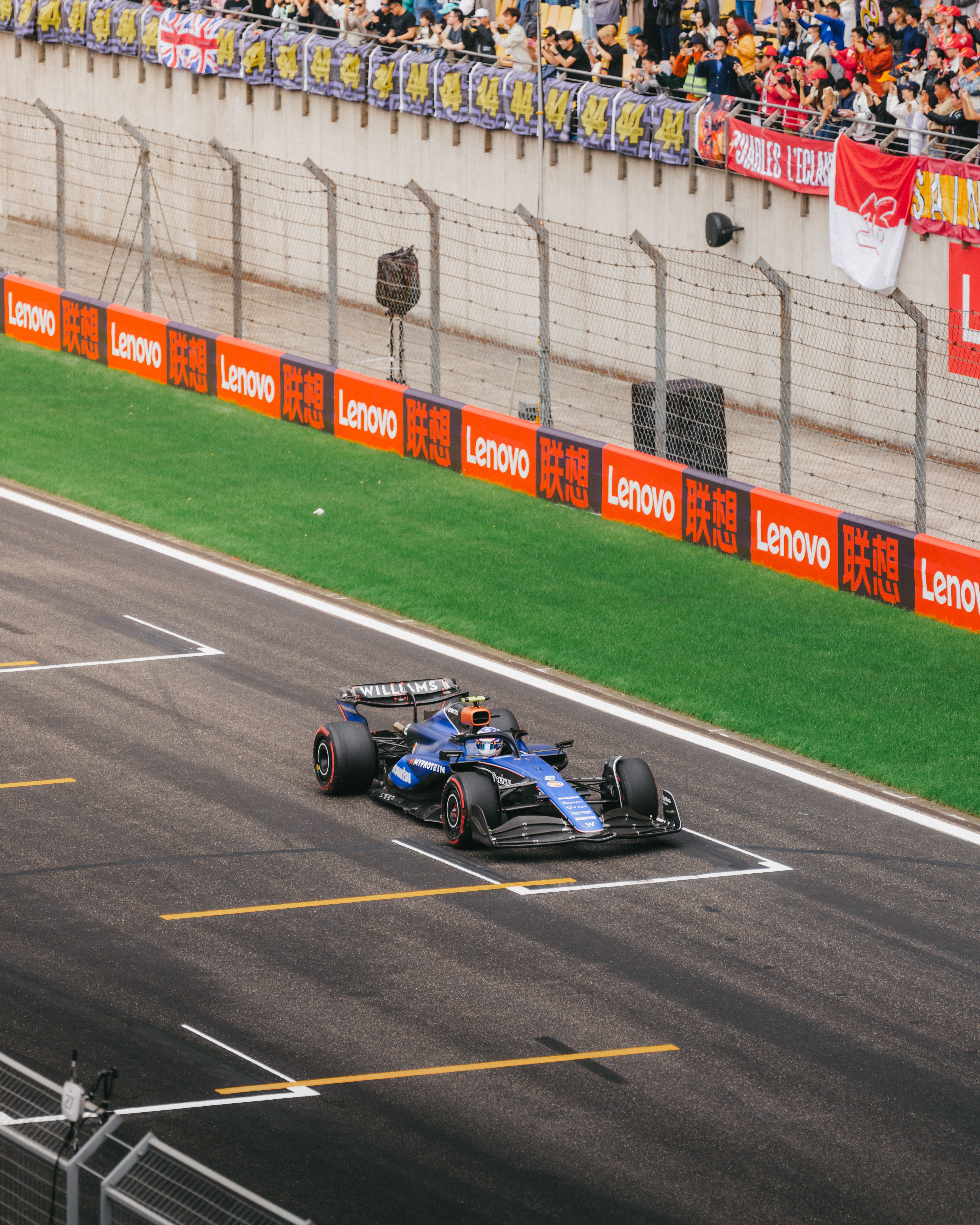 Logan looks at his pit board as he speeds down the pit straight.