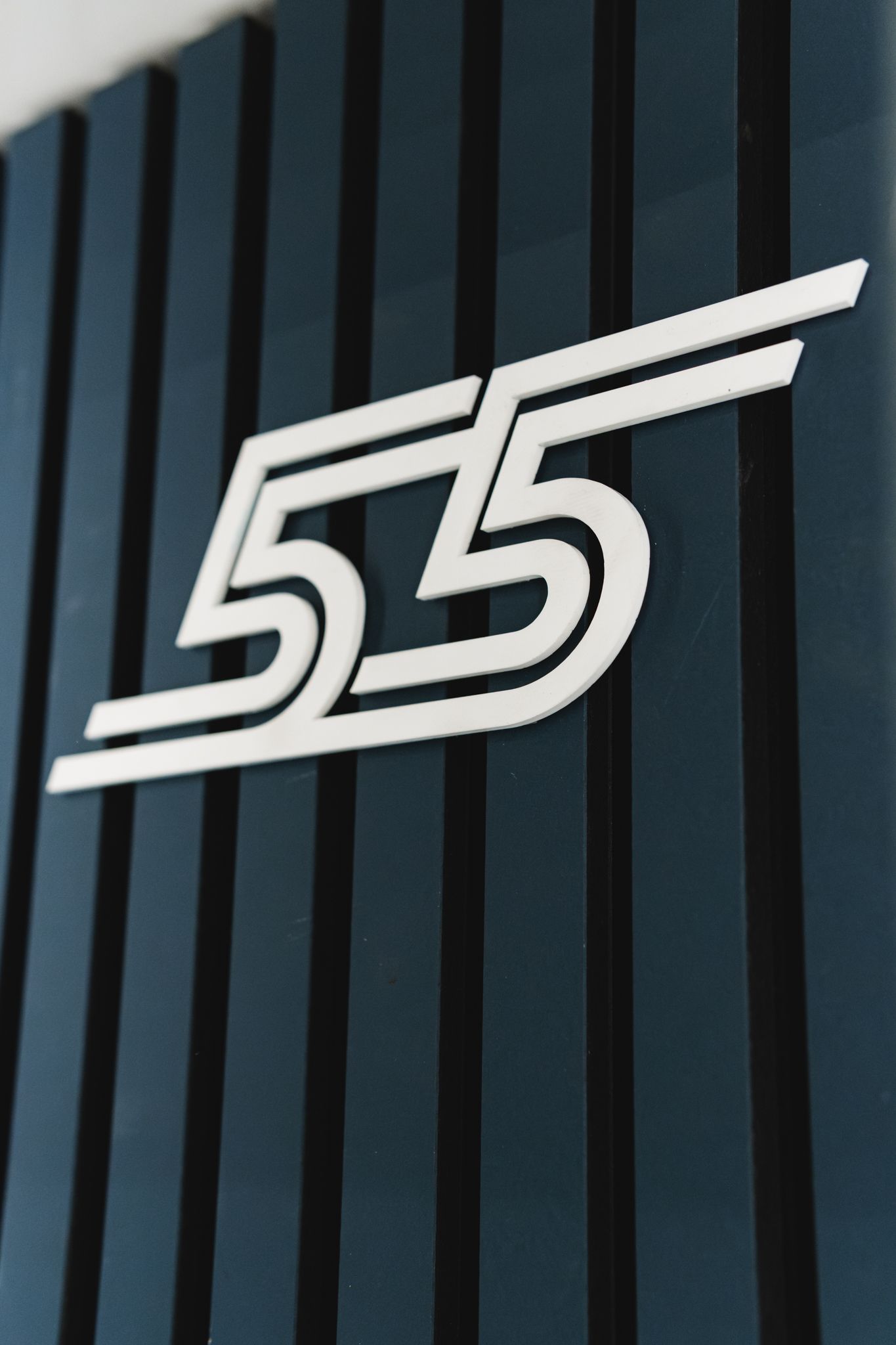 With a new logo on the wall.