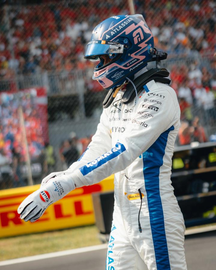 Alex Albon, Atlassian Williams Racing Formula 1 driver, at the 2025 Italian Grand Prix wearing helmet and race suit on the grid