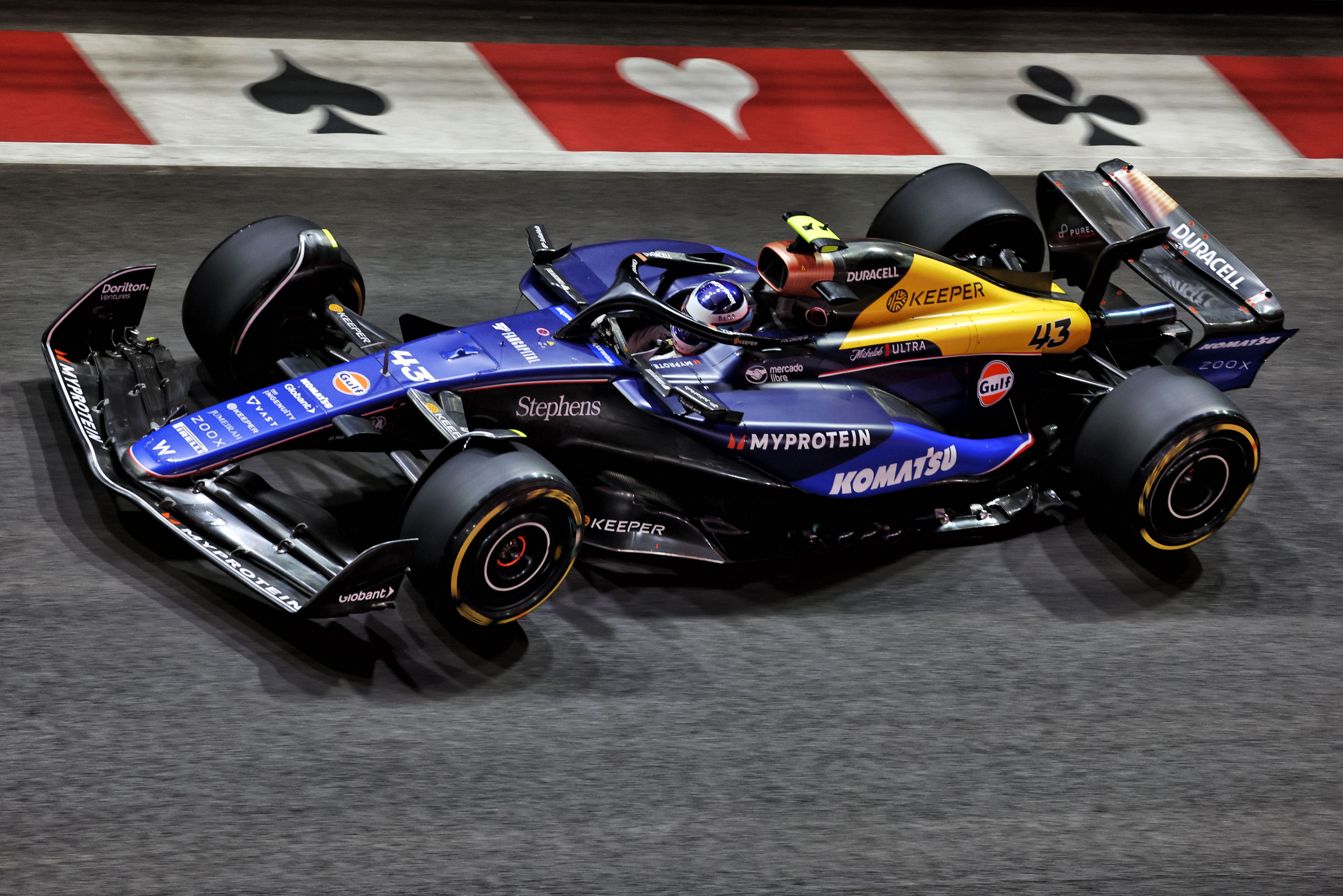 The yellow Keeper engine cover popping under the lights.