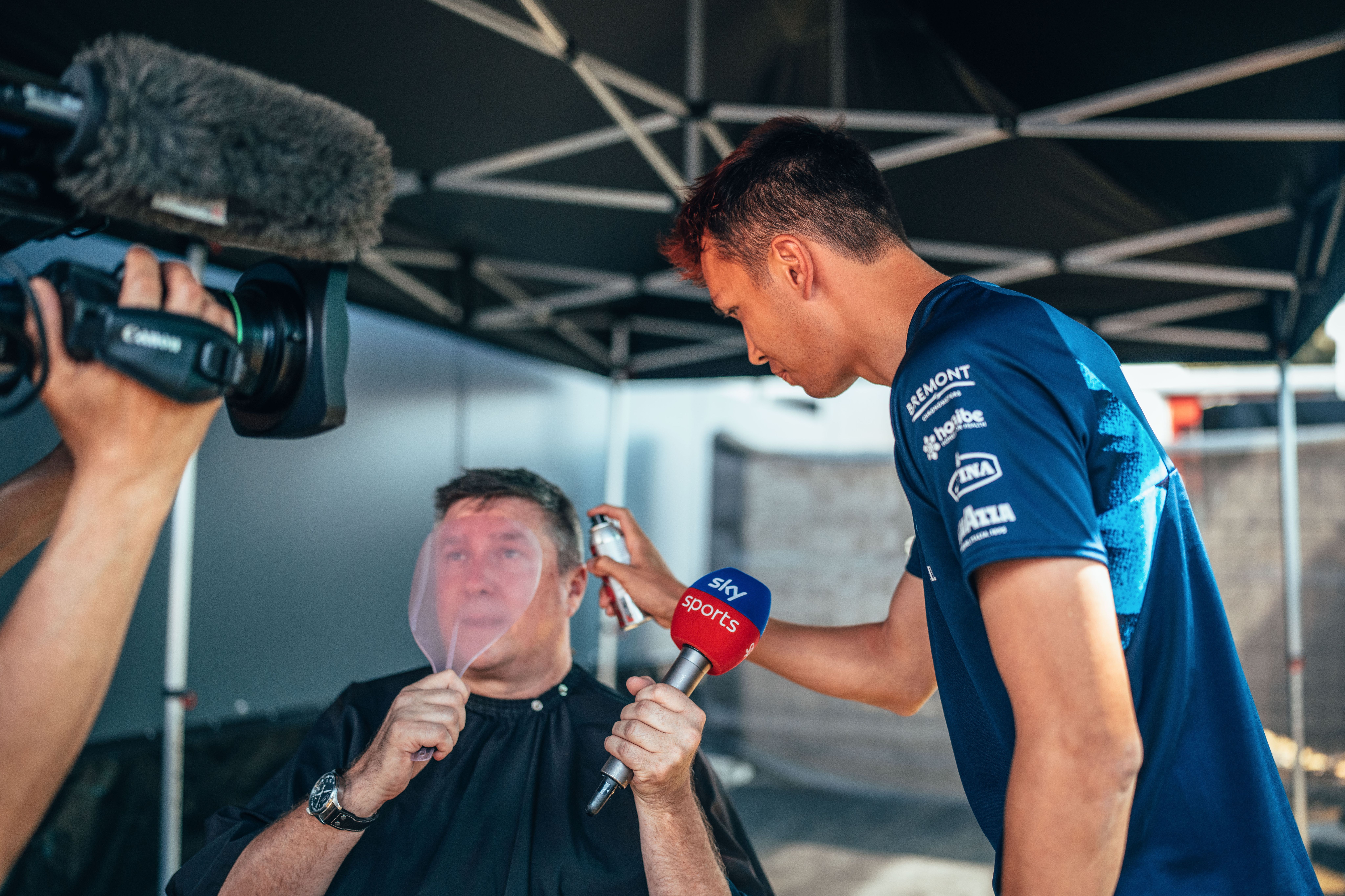 Albono’s Barbers was in full flow in May 2022. Alex’s changing hair colour has become a big part of his identity!