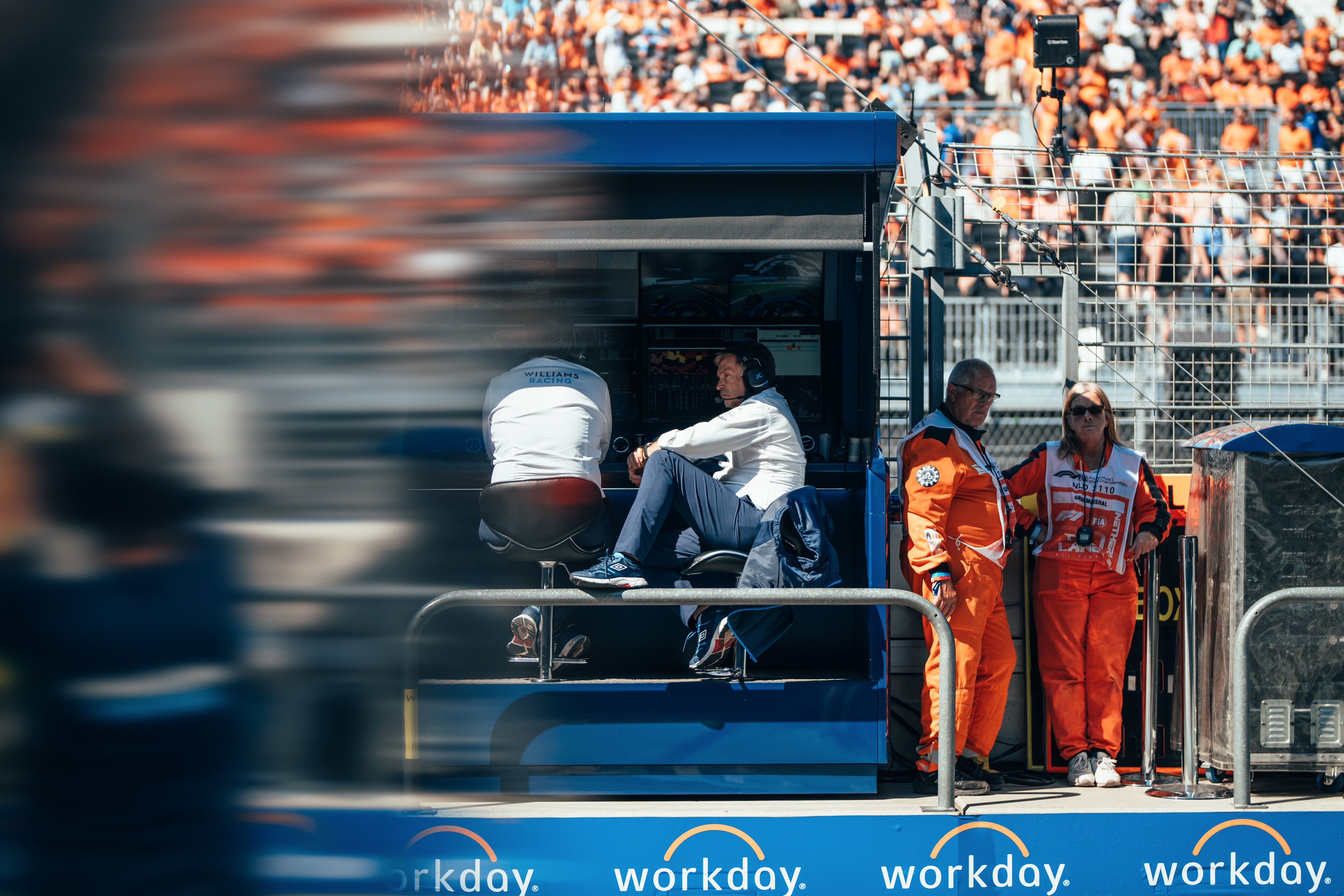 One leg up like he runs the place… The boss watches from the pit wall.
