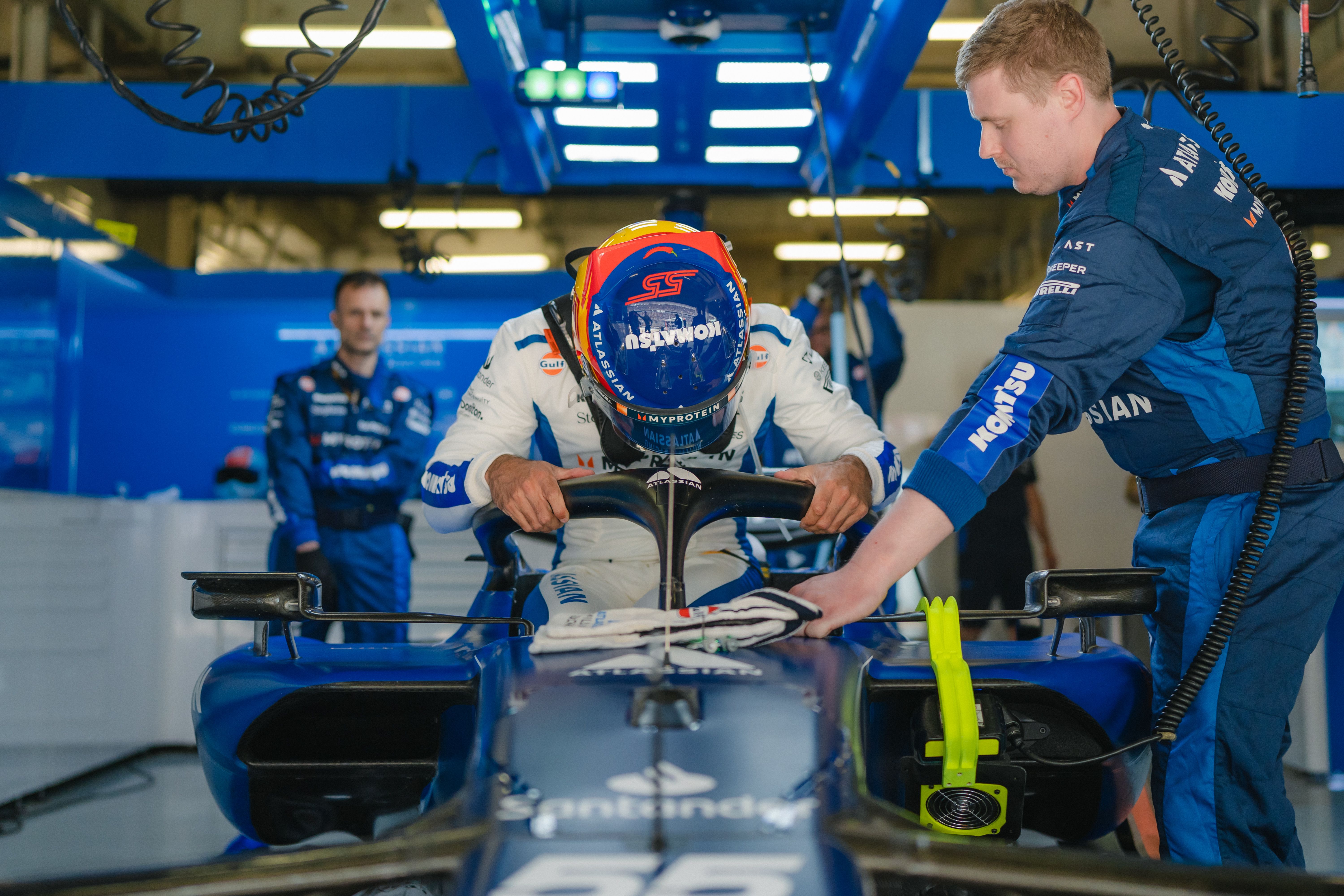 Carlos lowers himself into the car