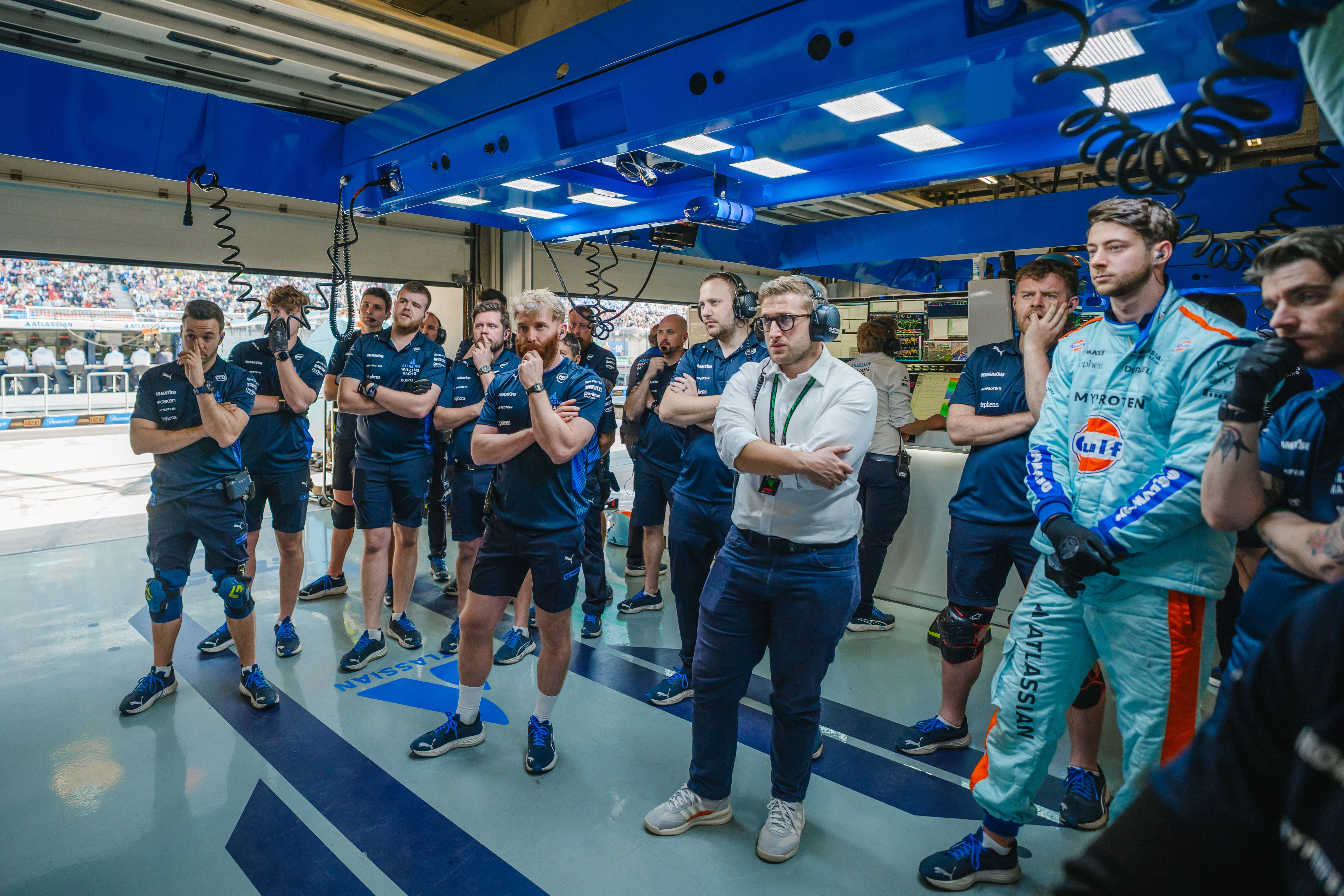 The pit crew watch on