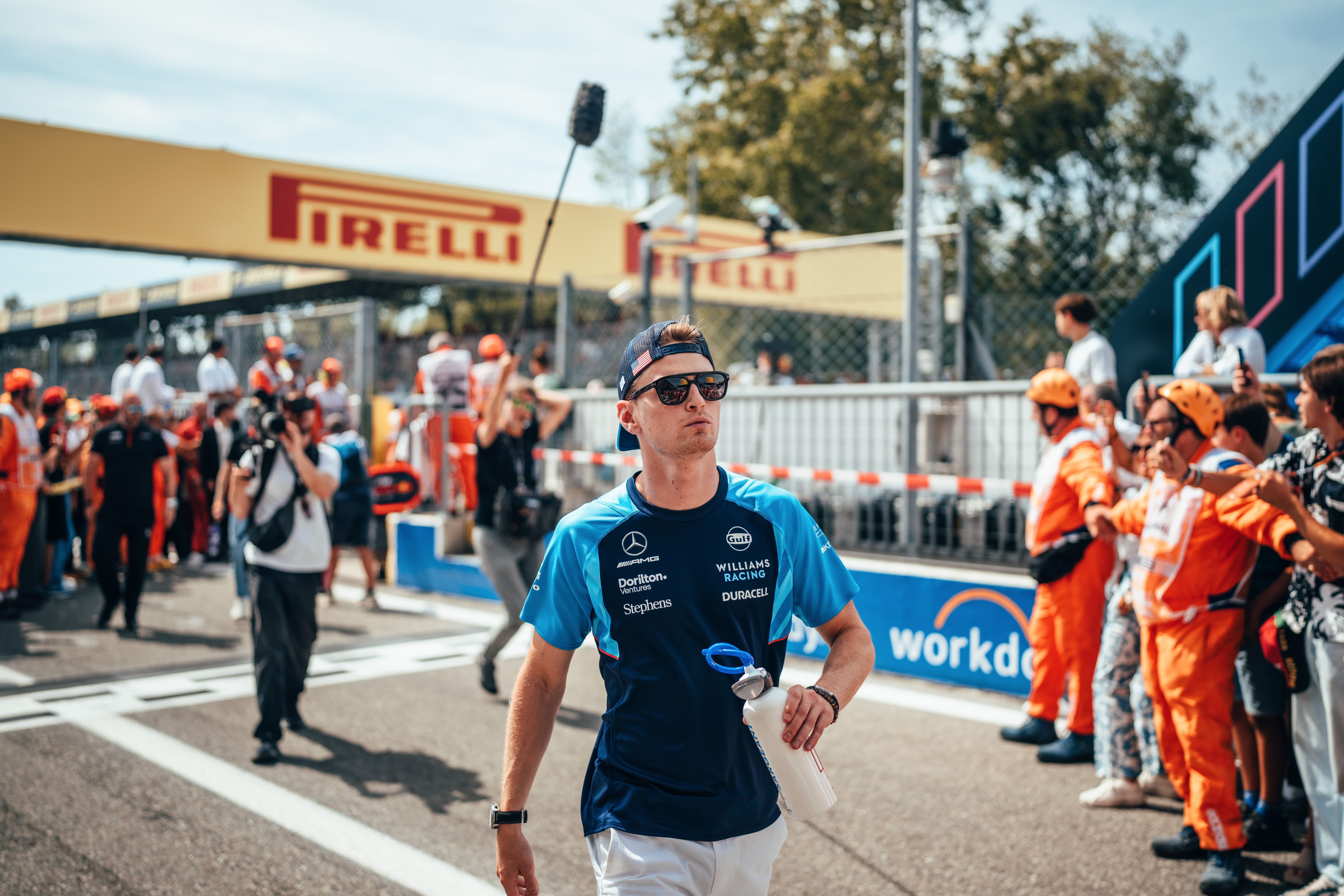 Walking with purpose. Logan explores the grid pre-race.