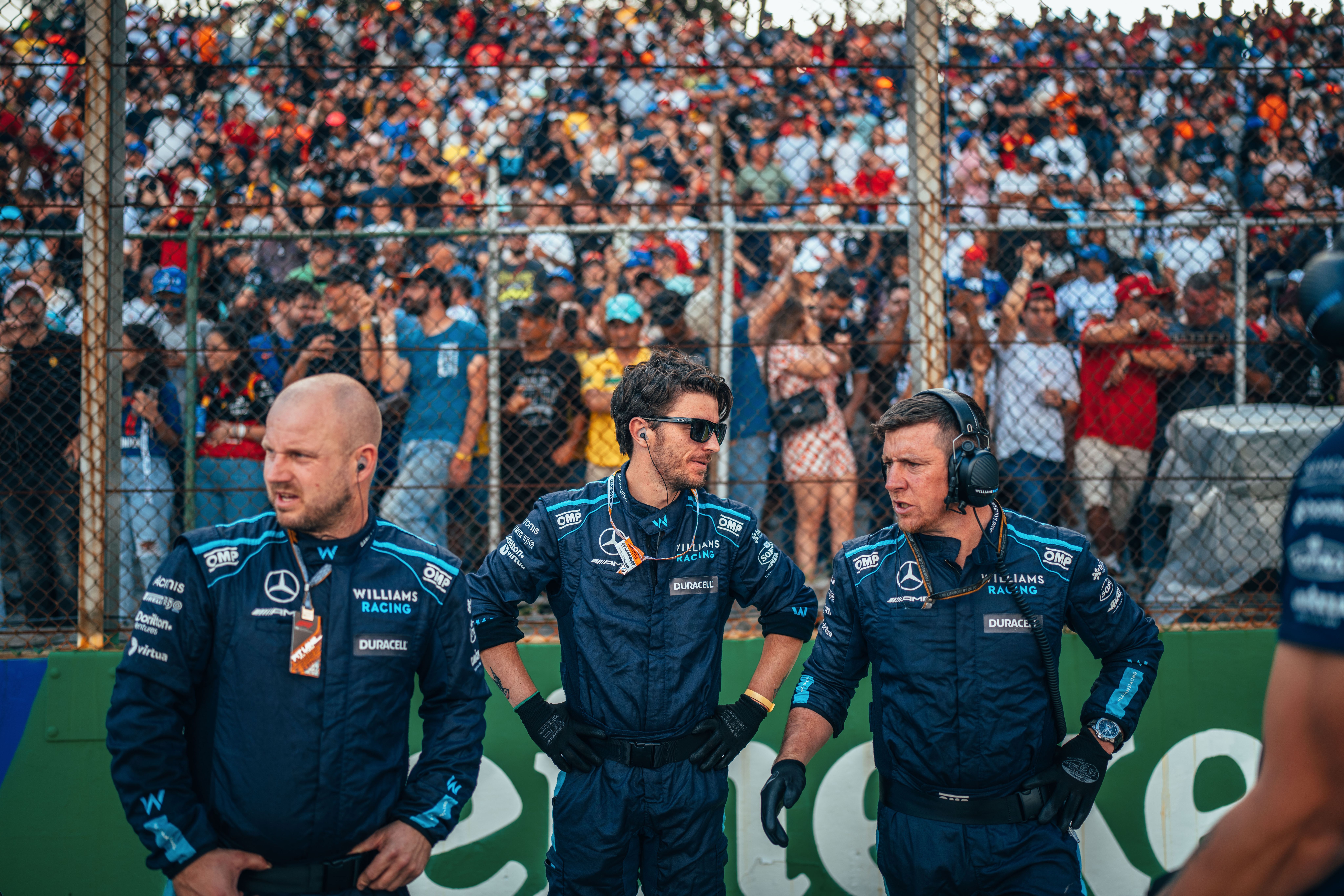The team wait for the FW44s to arrive on the grid in front of the packed grandstands.