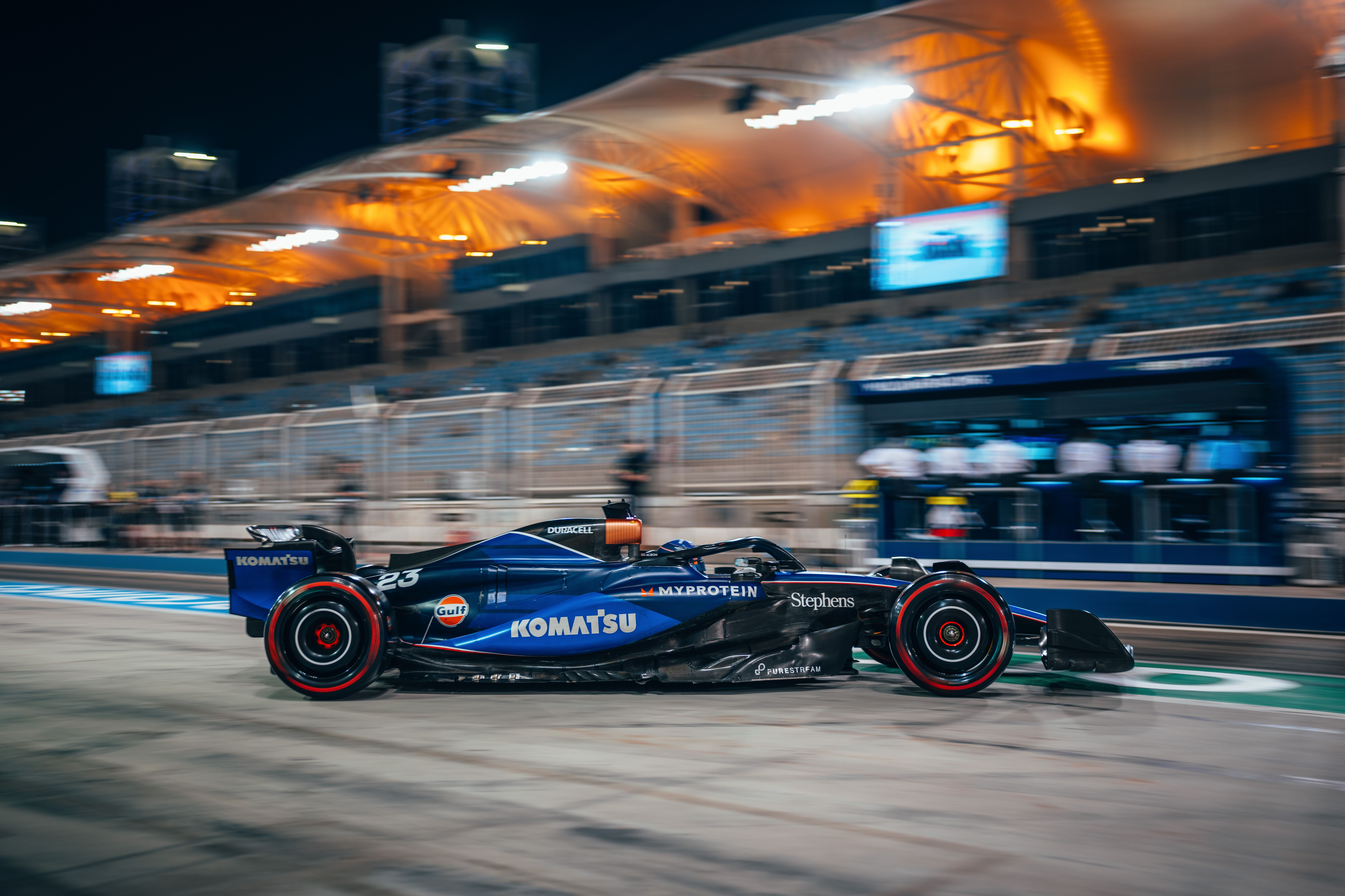 Day turns to night in the pit lane.