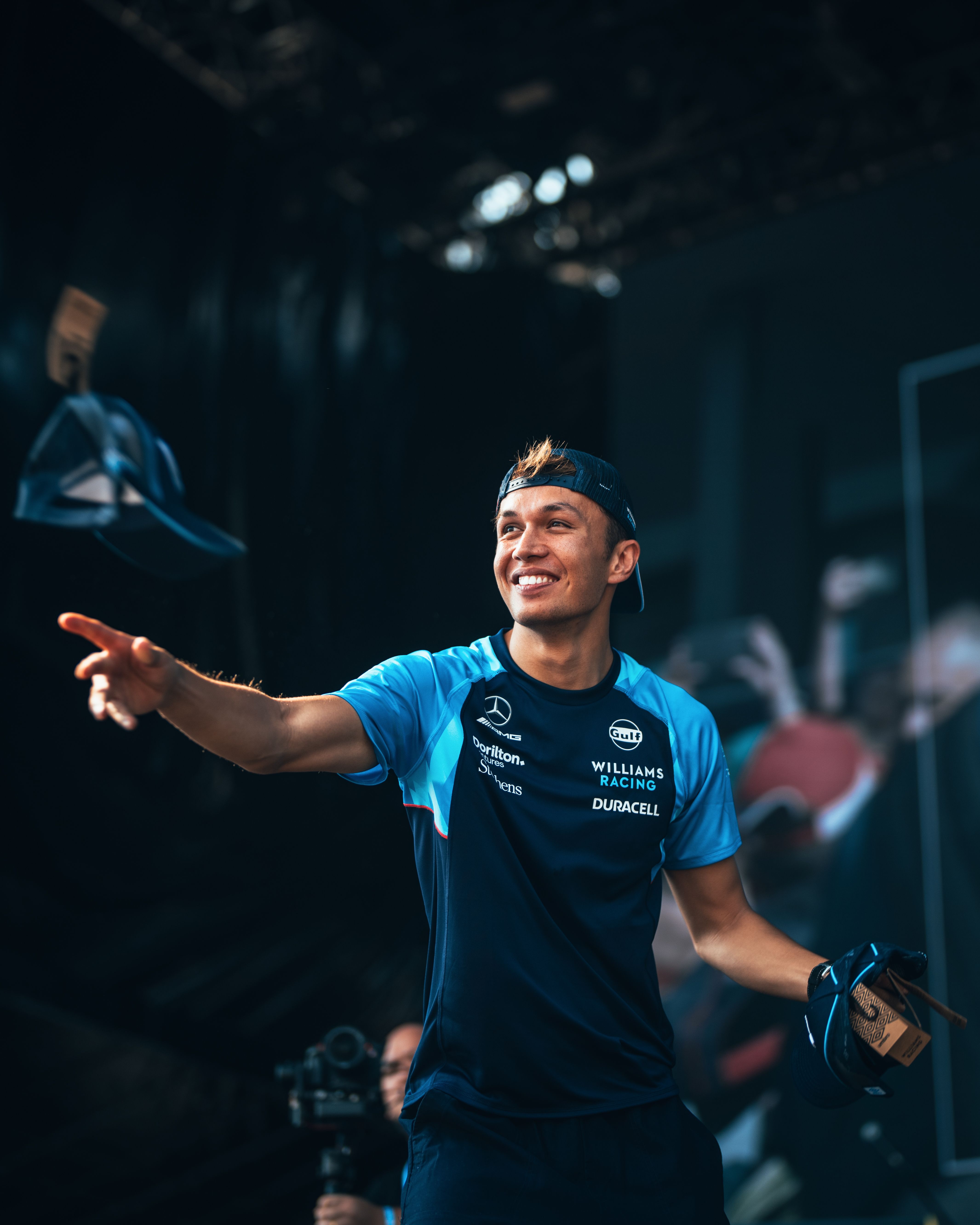 Time for some freebies! Alex throws a cap into the crowd.