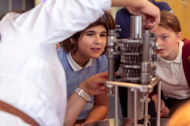 Two children discover the inner workings of an F1 car during a recent International Women in Engineering Day workshop