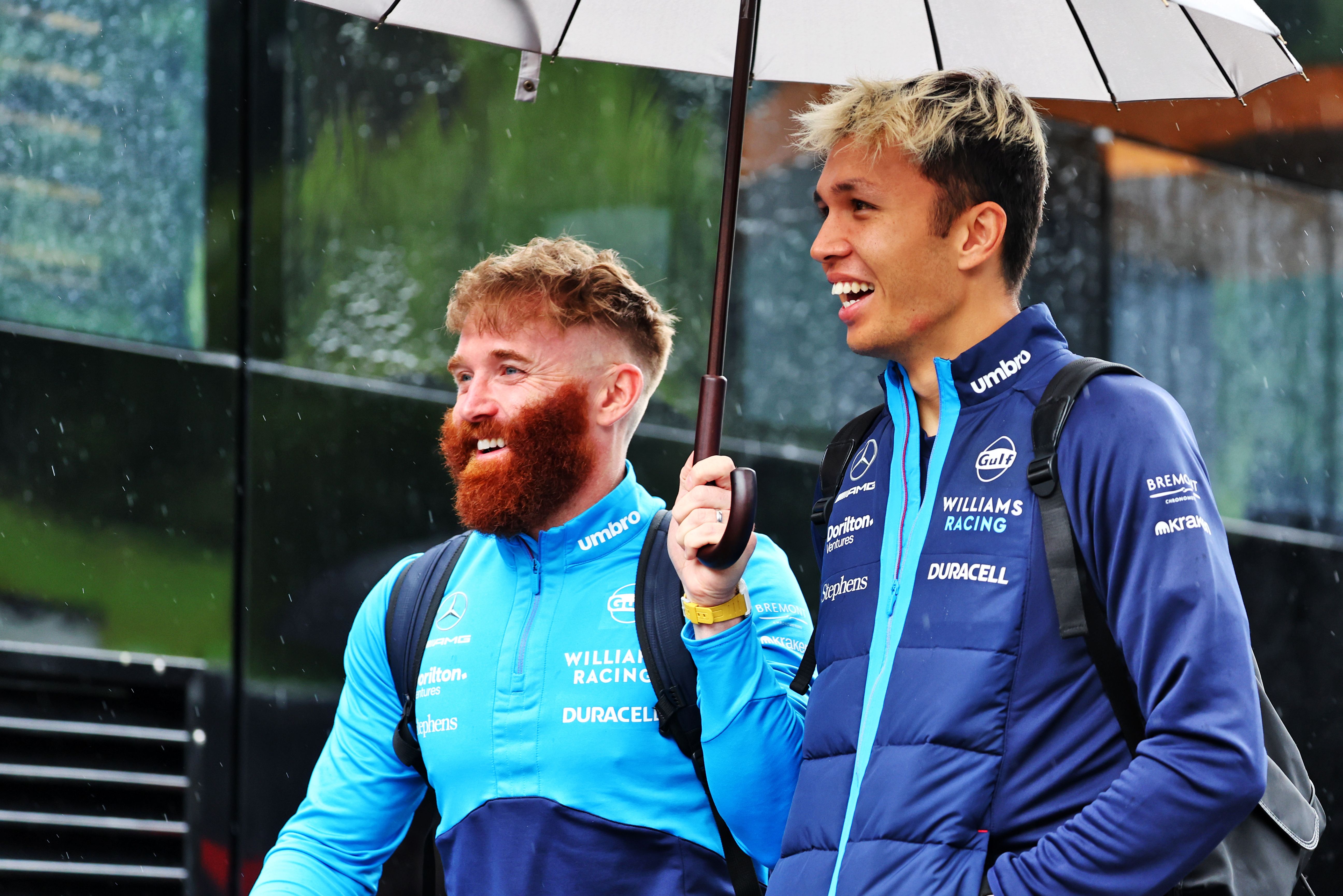 Singing in the rain? We can’t tell, but the showers sure put a smile on Alex and Patrick’s faces.