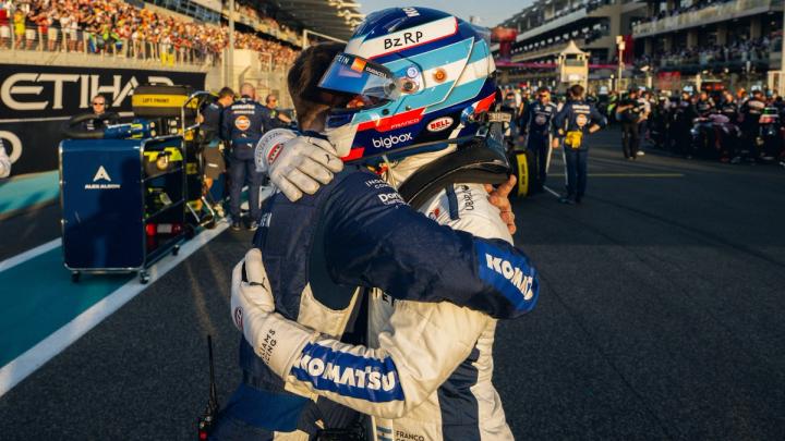 Franco Colapinto hugs a memeber of the Williams team on the Abu Dhabi grid