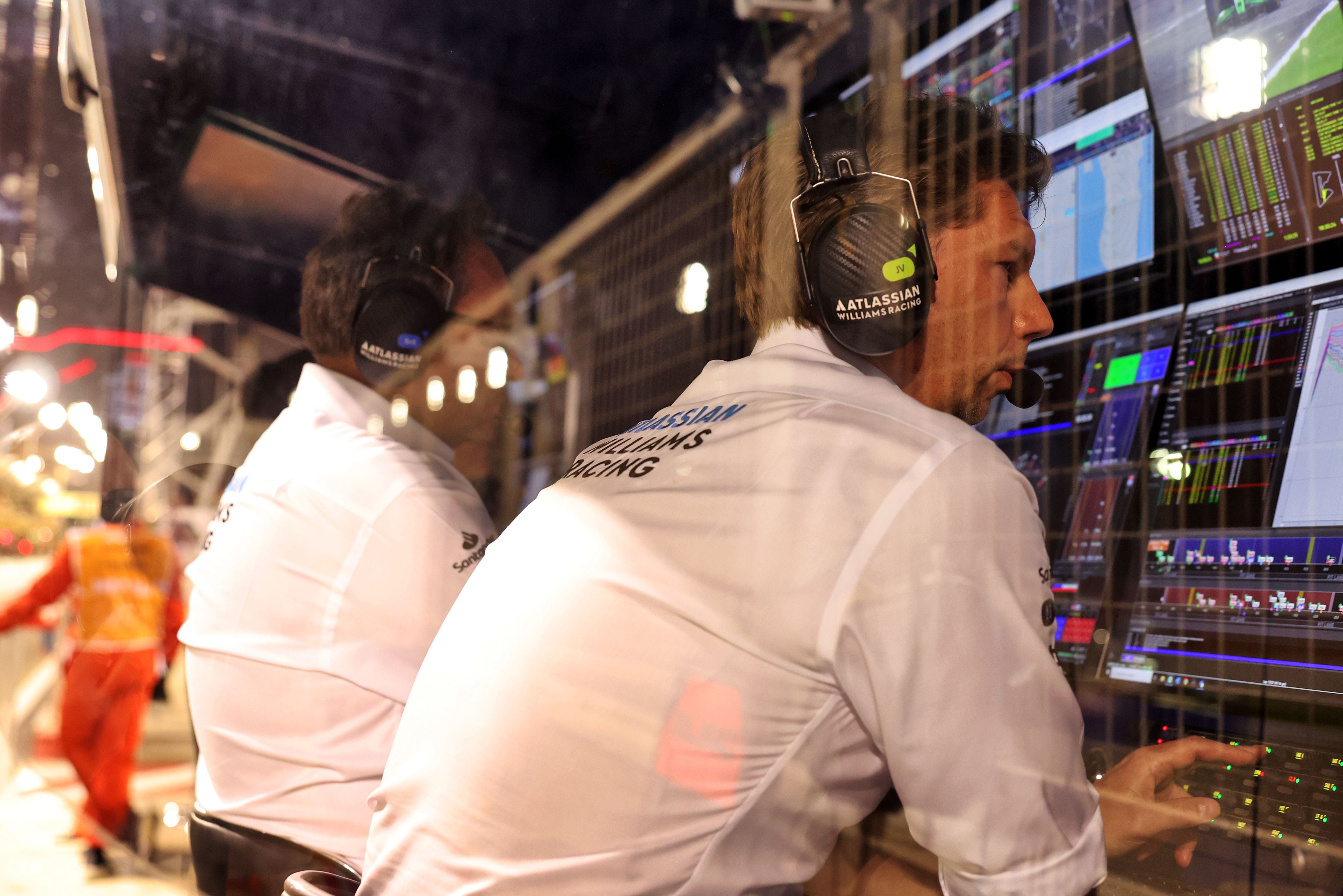 James monitors the race from the pit wall