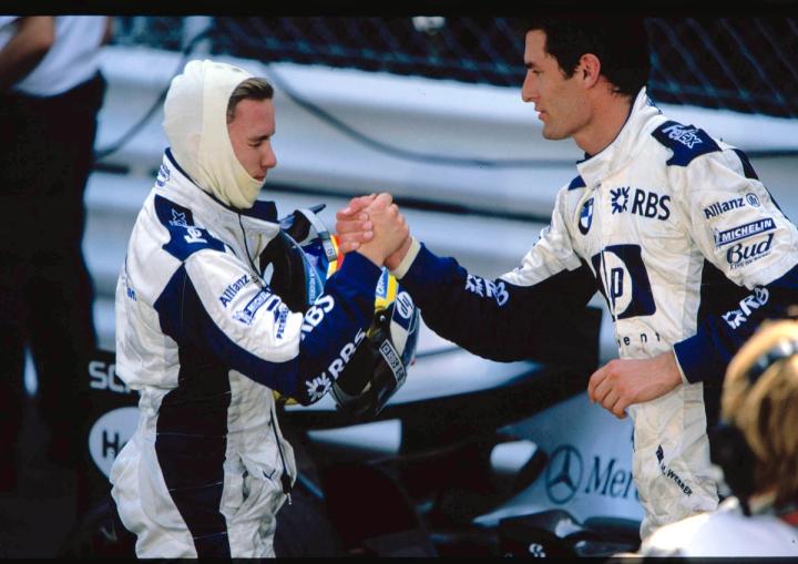Nick Heidfeld and Mark Webber embrace after their podium result in 2005