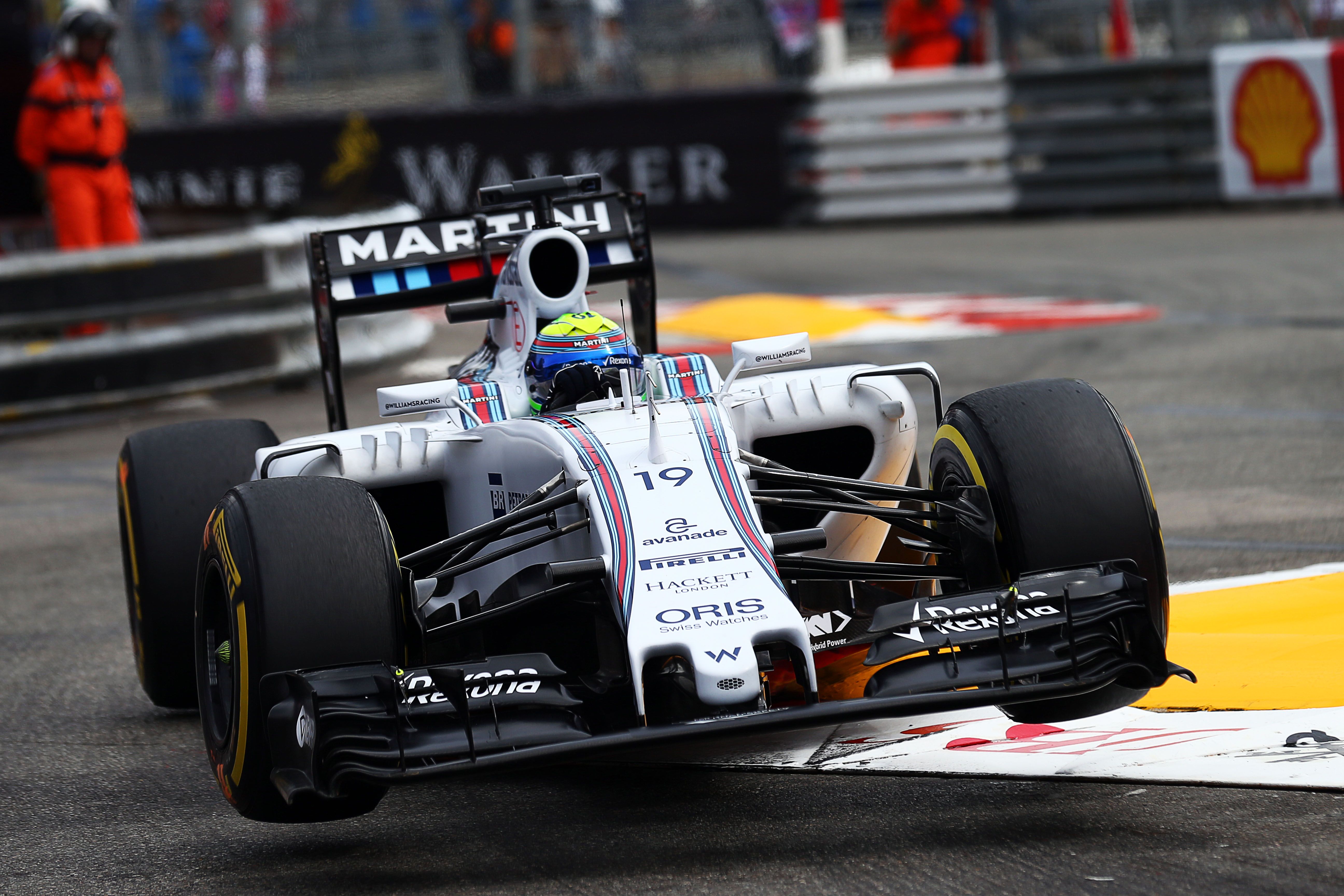 Felipe Massa attacks the kerbs at the swimming pool in his FW37.