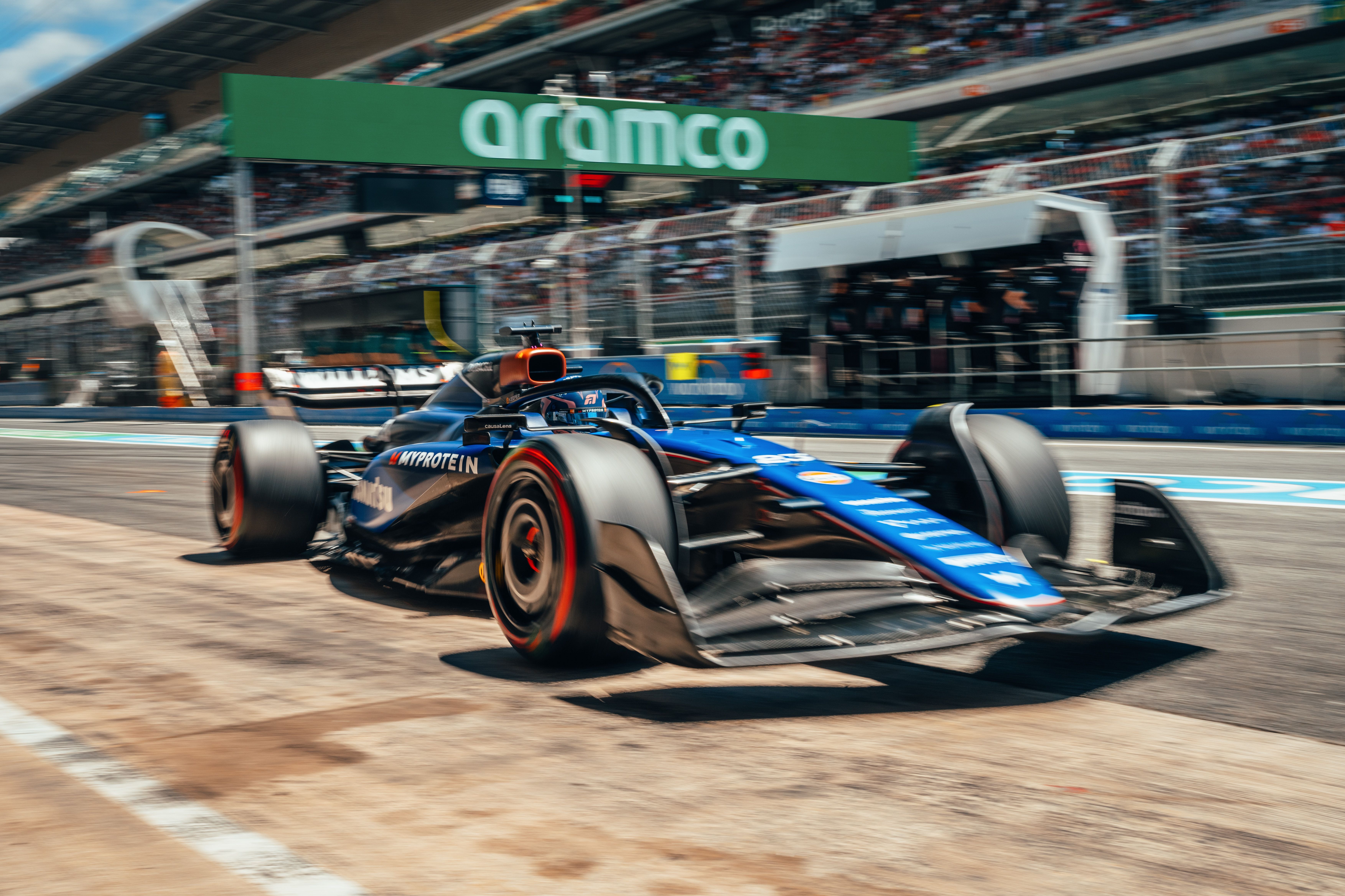 Racing out the pit lane.